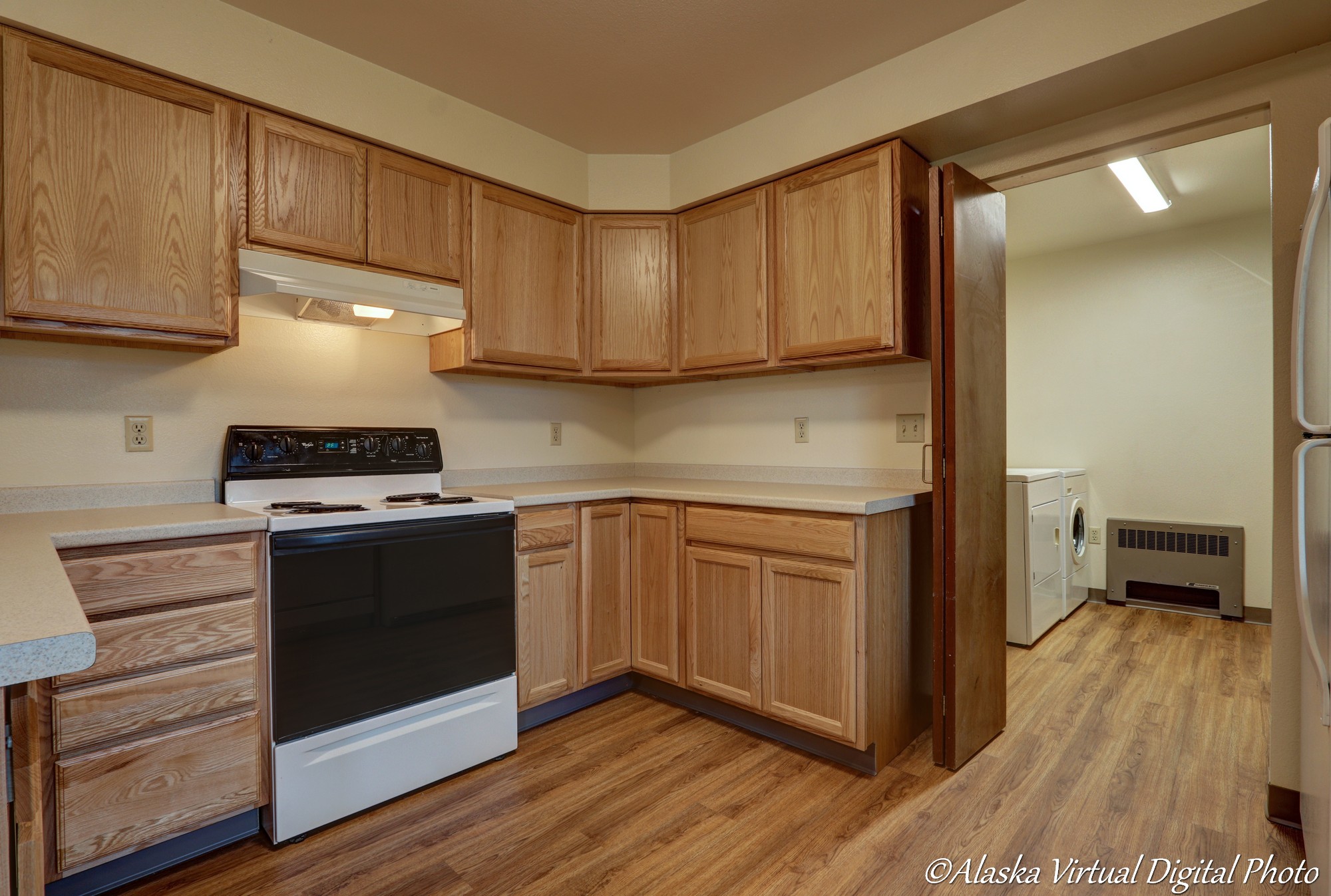 image of kitchen with wood cabinets and wood floors