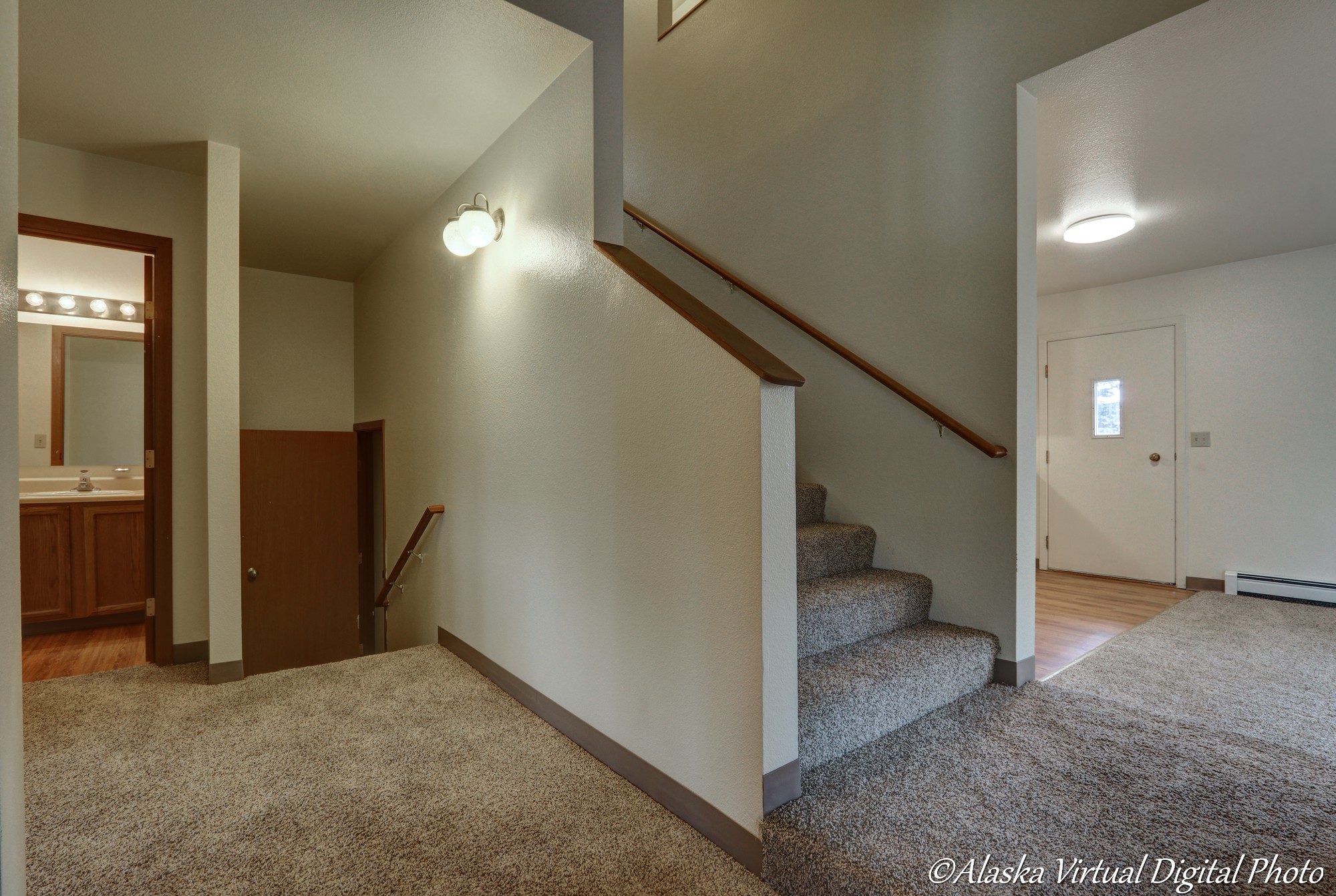 image of entry area with view of stairs, part of living room, part of bathroom