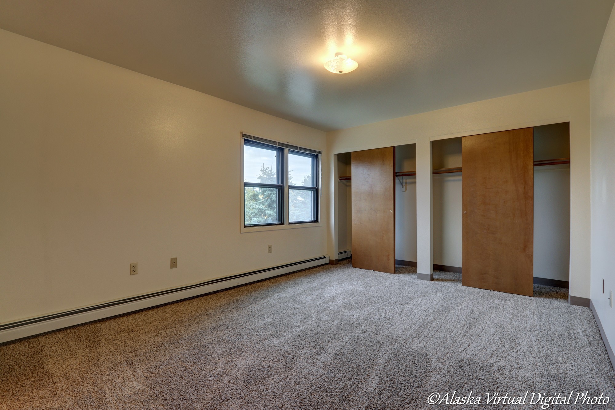 image of master bedroom with view of double bypass door closets