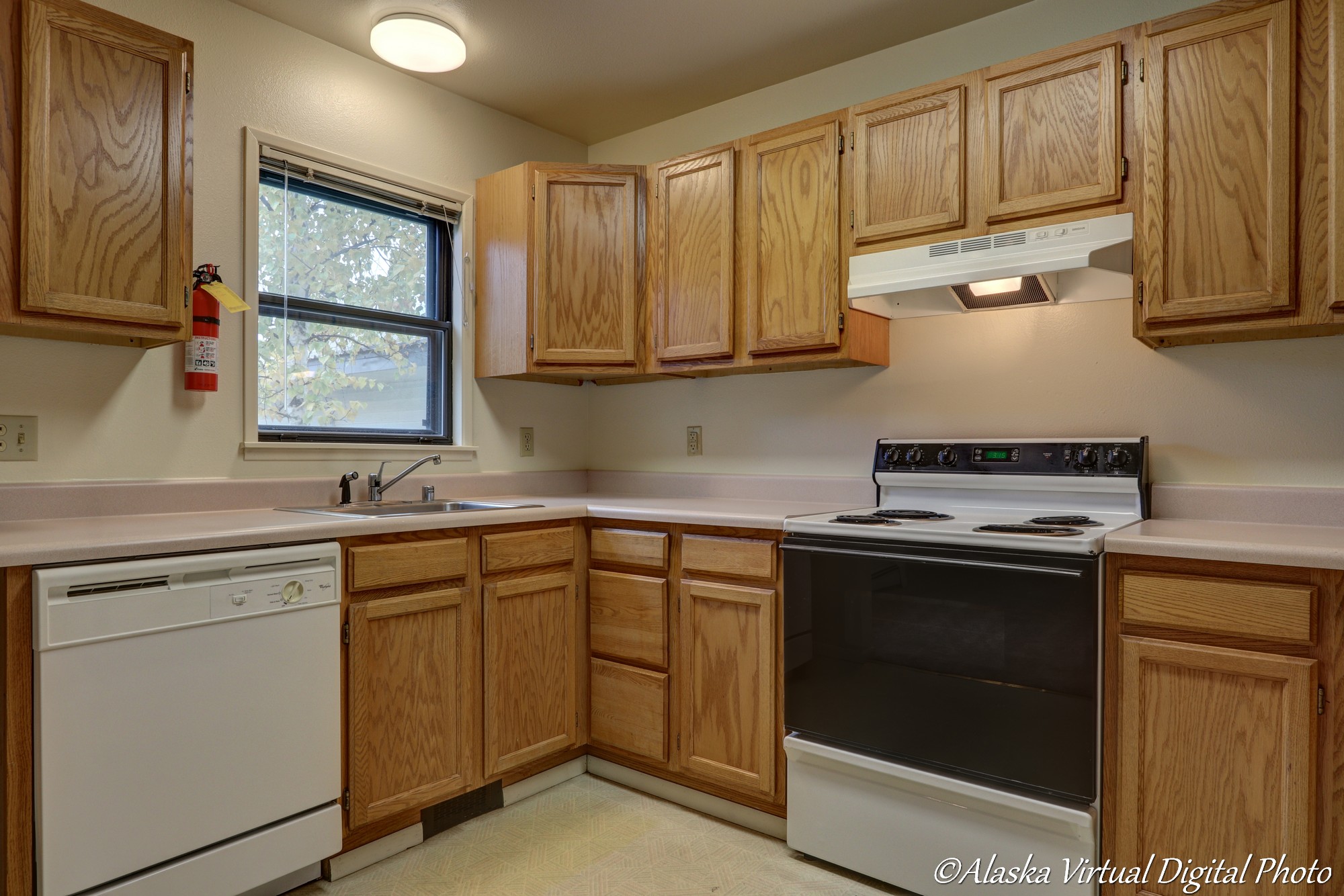 Photo of kitchen including oven, dishwasher and sink