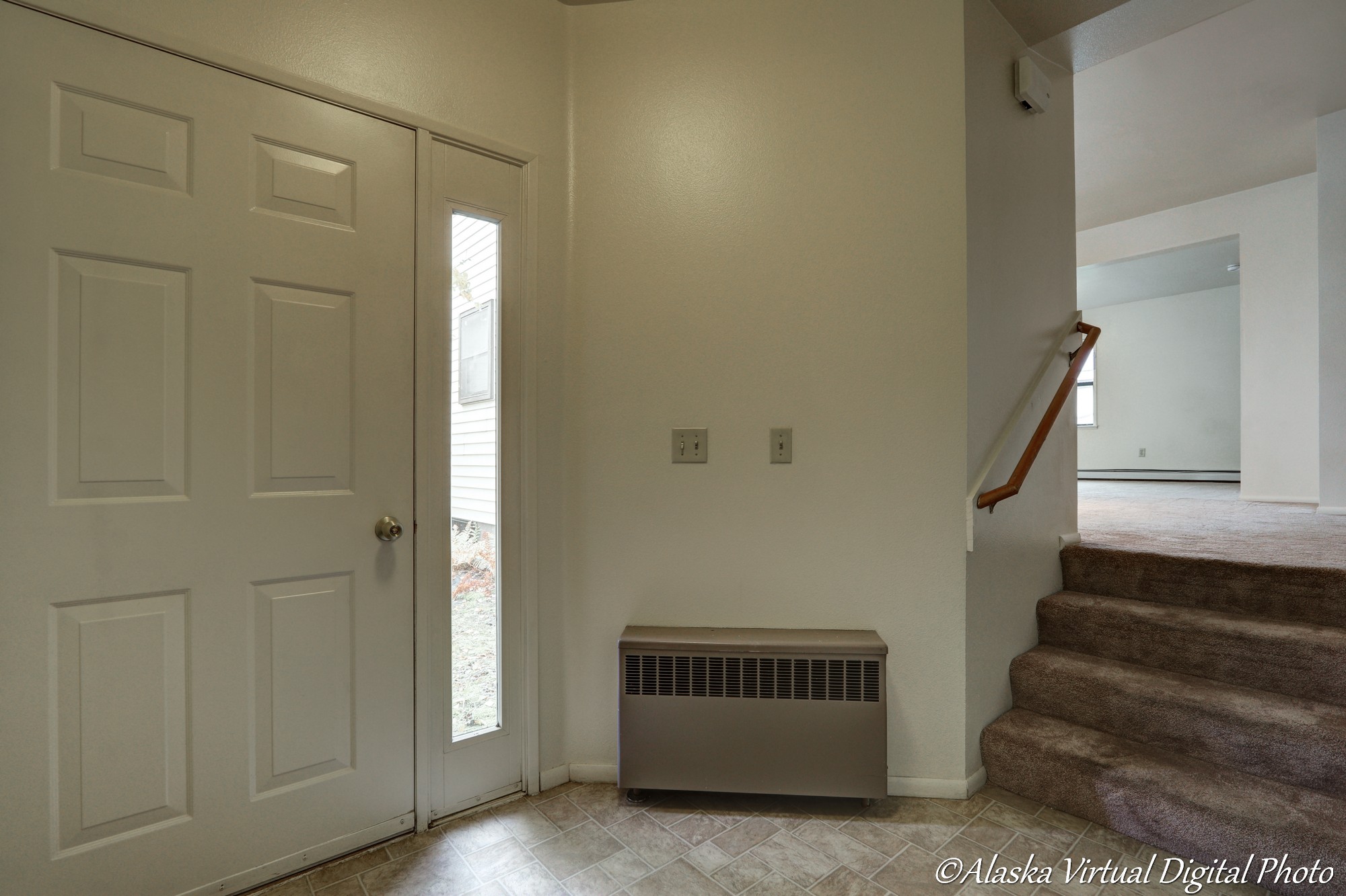 Front door with steps leading up to dining area