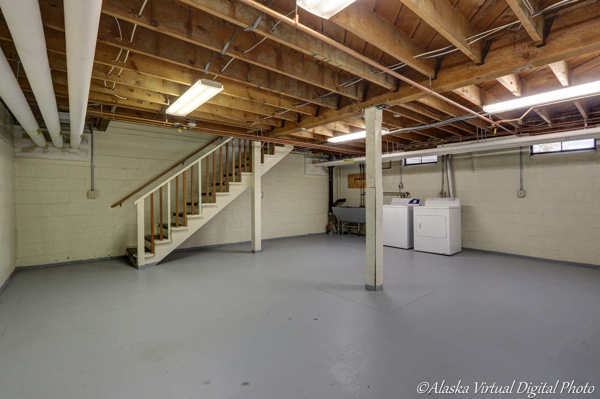 Photo of unfinished basement with laundry