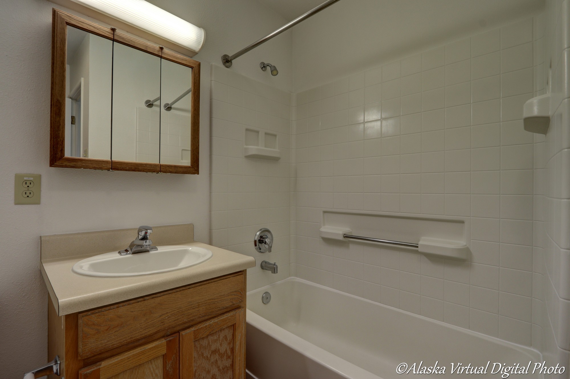 Image of bathroom with medicine cabinet/mirror combo and bathtub