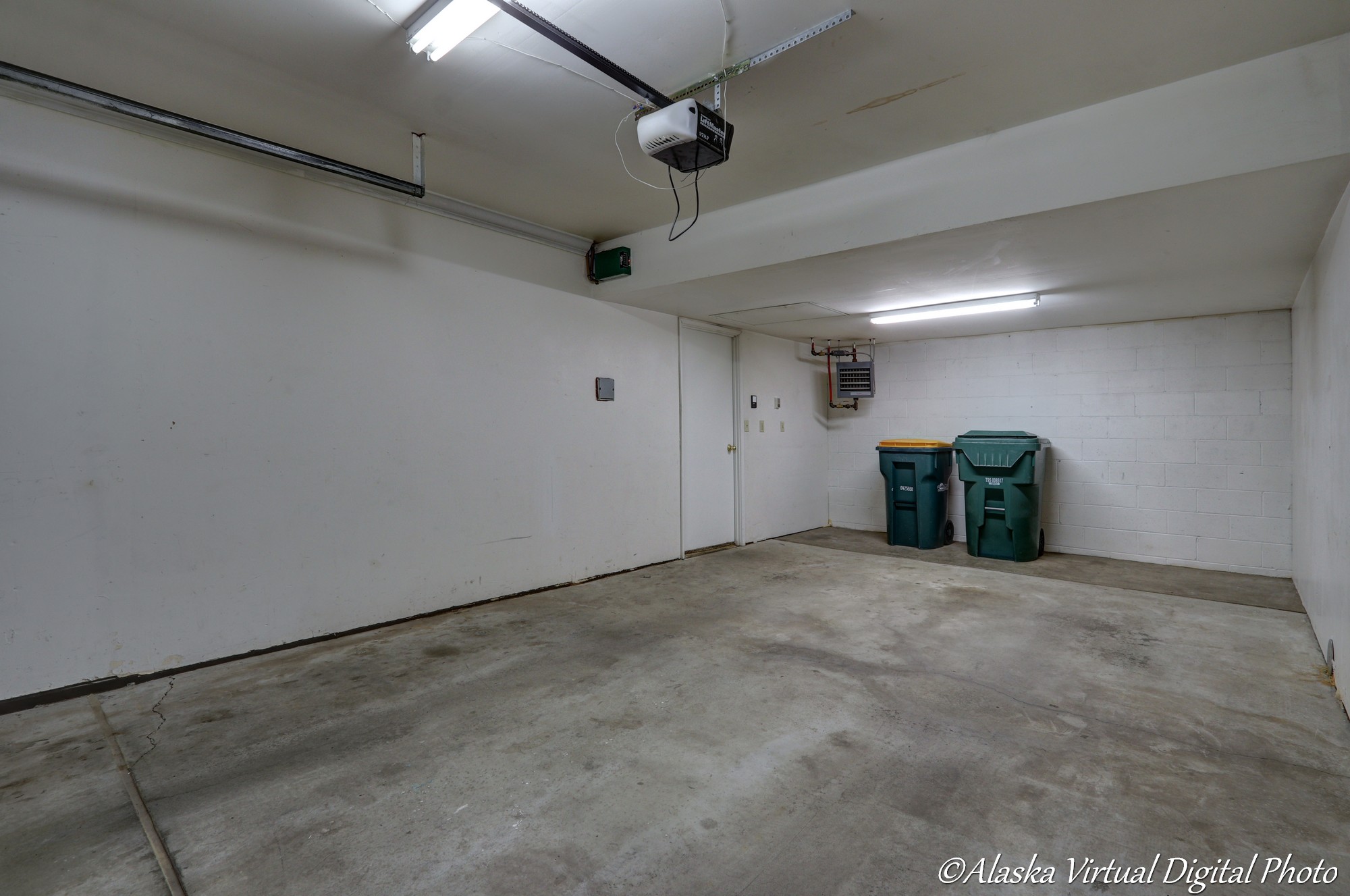 image of garage with recycling and trash recepticles