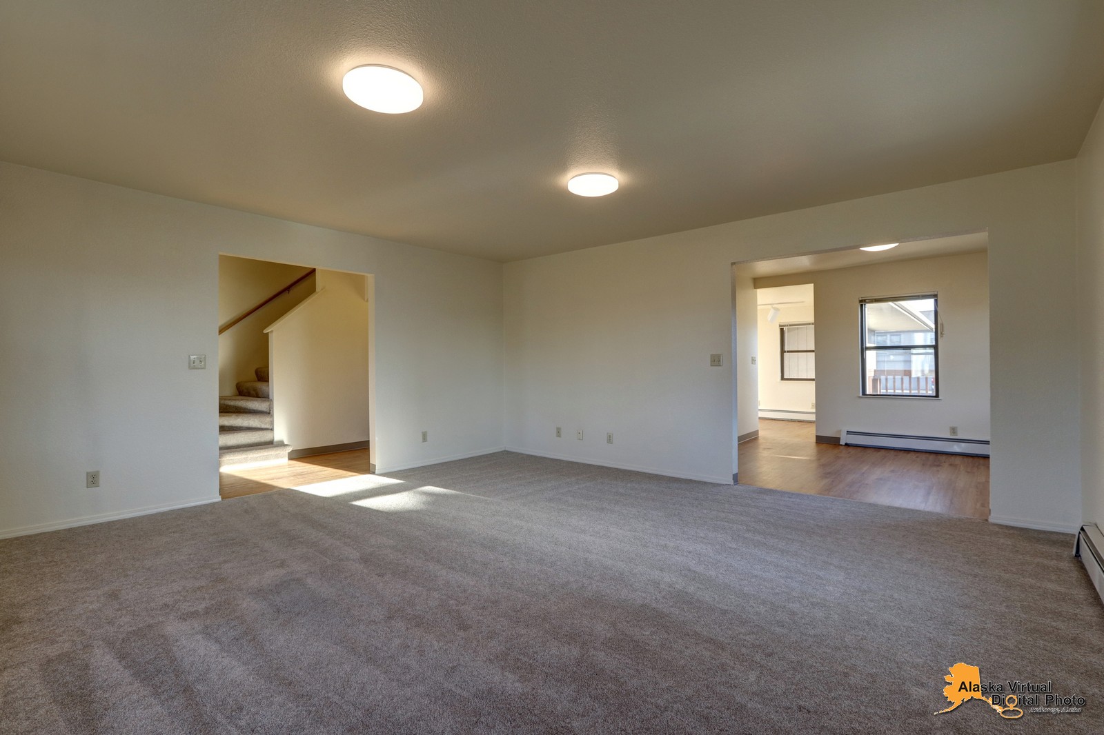 Living room with view into kitchen