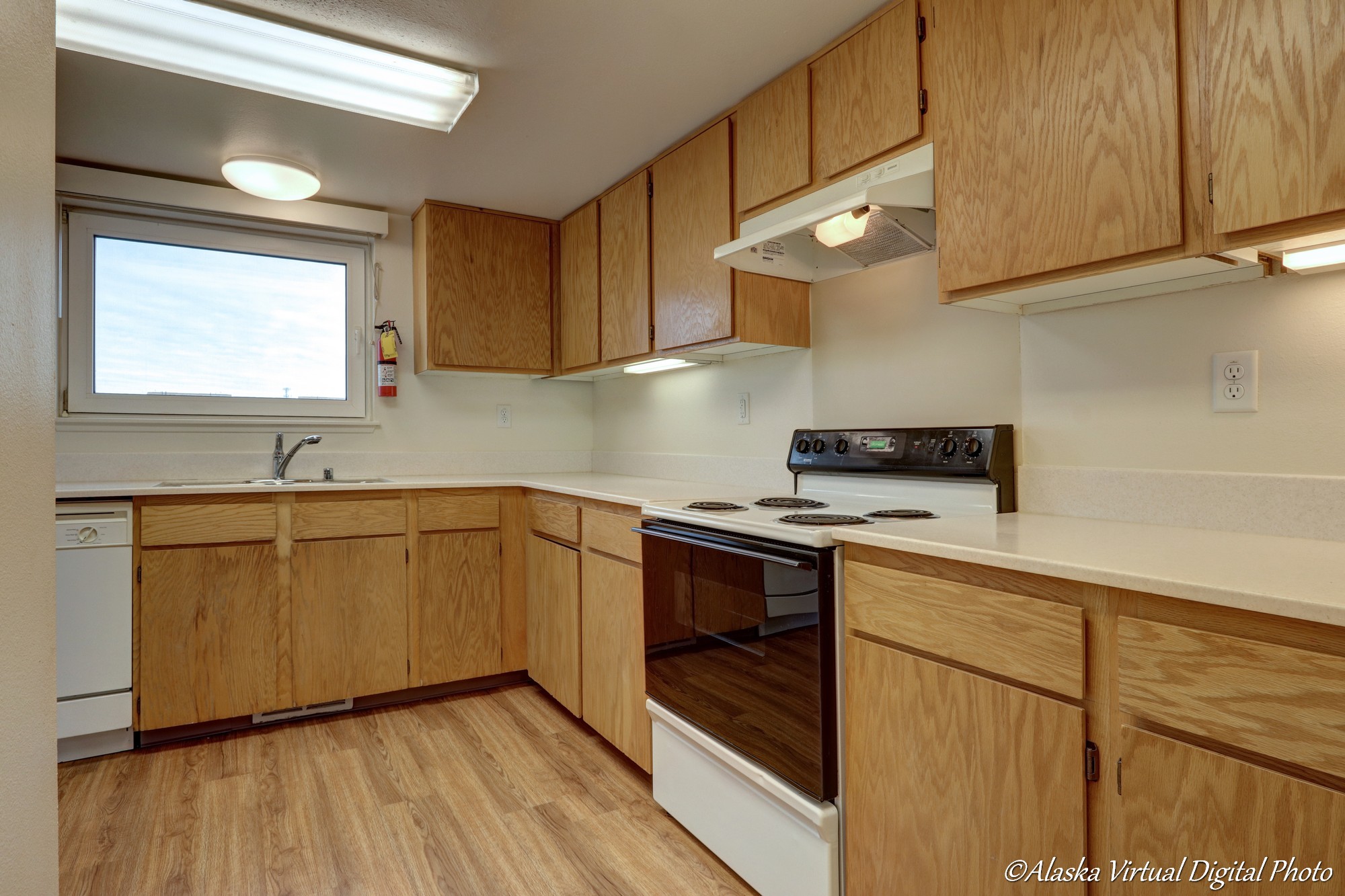 Kitchen with white countertops and wooden cabinets