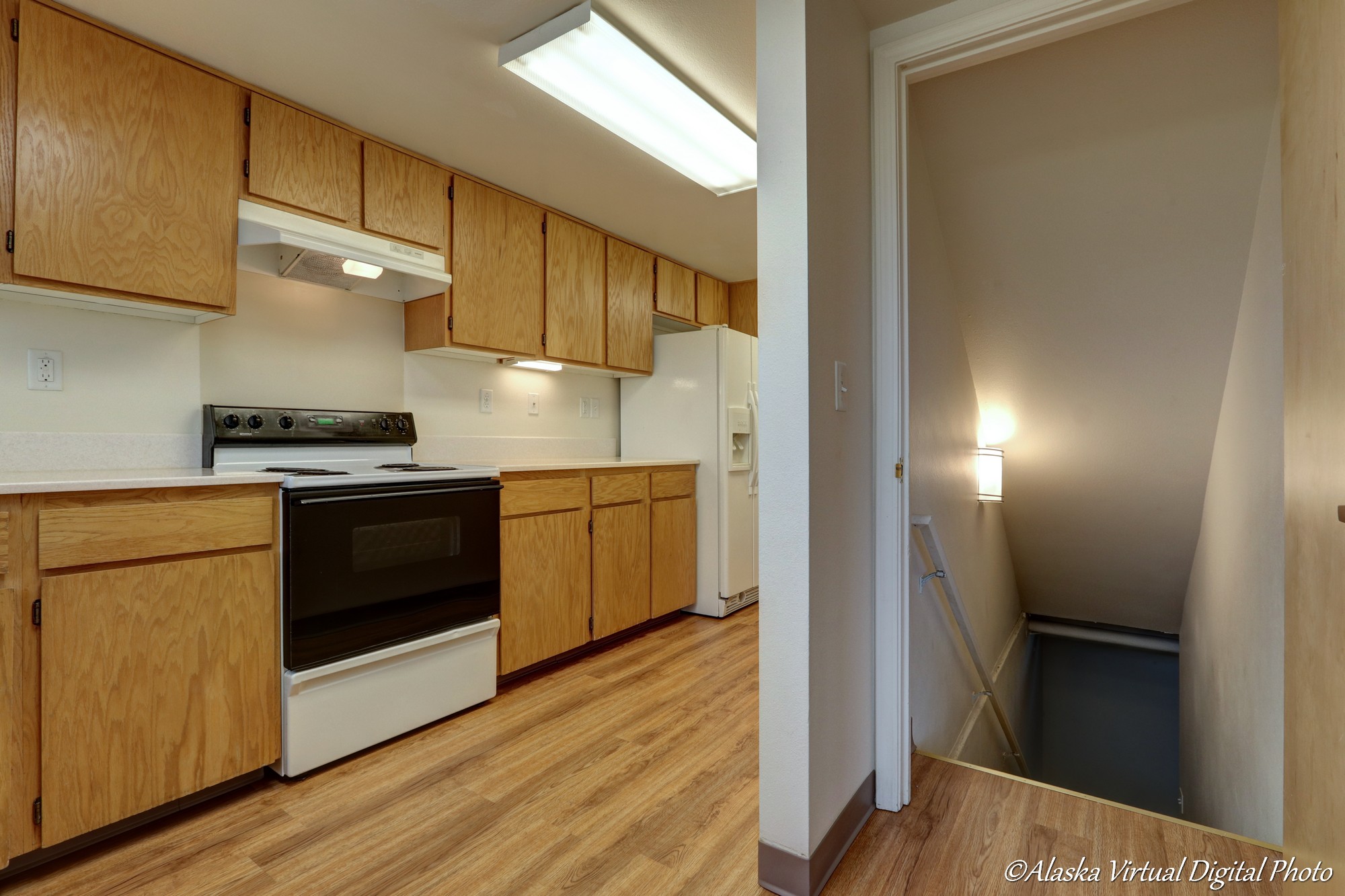 Range and counters on left with entry to basement on right