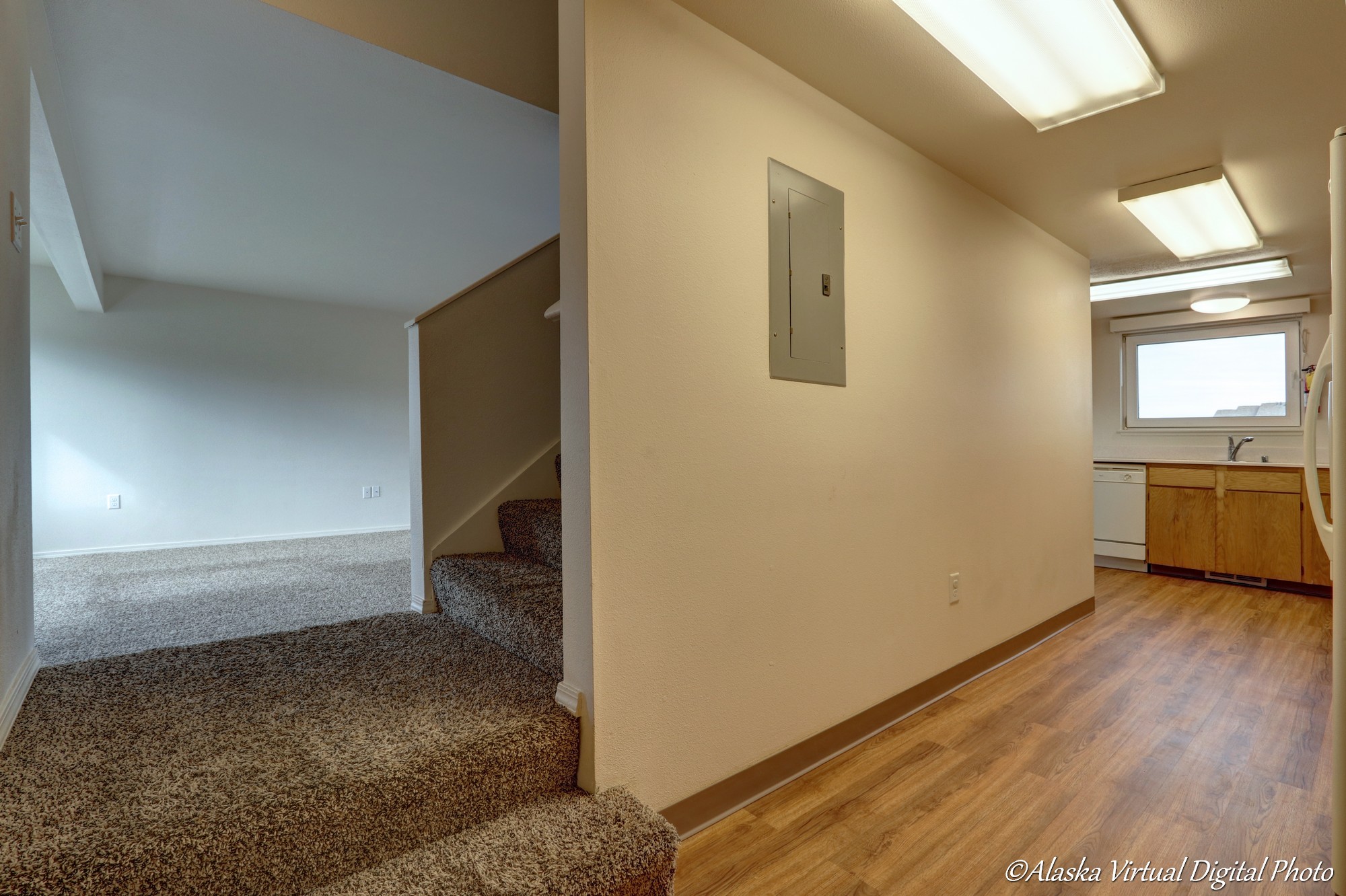 Entry with living area and stairs leading up.