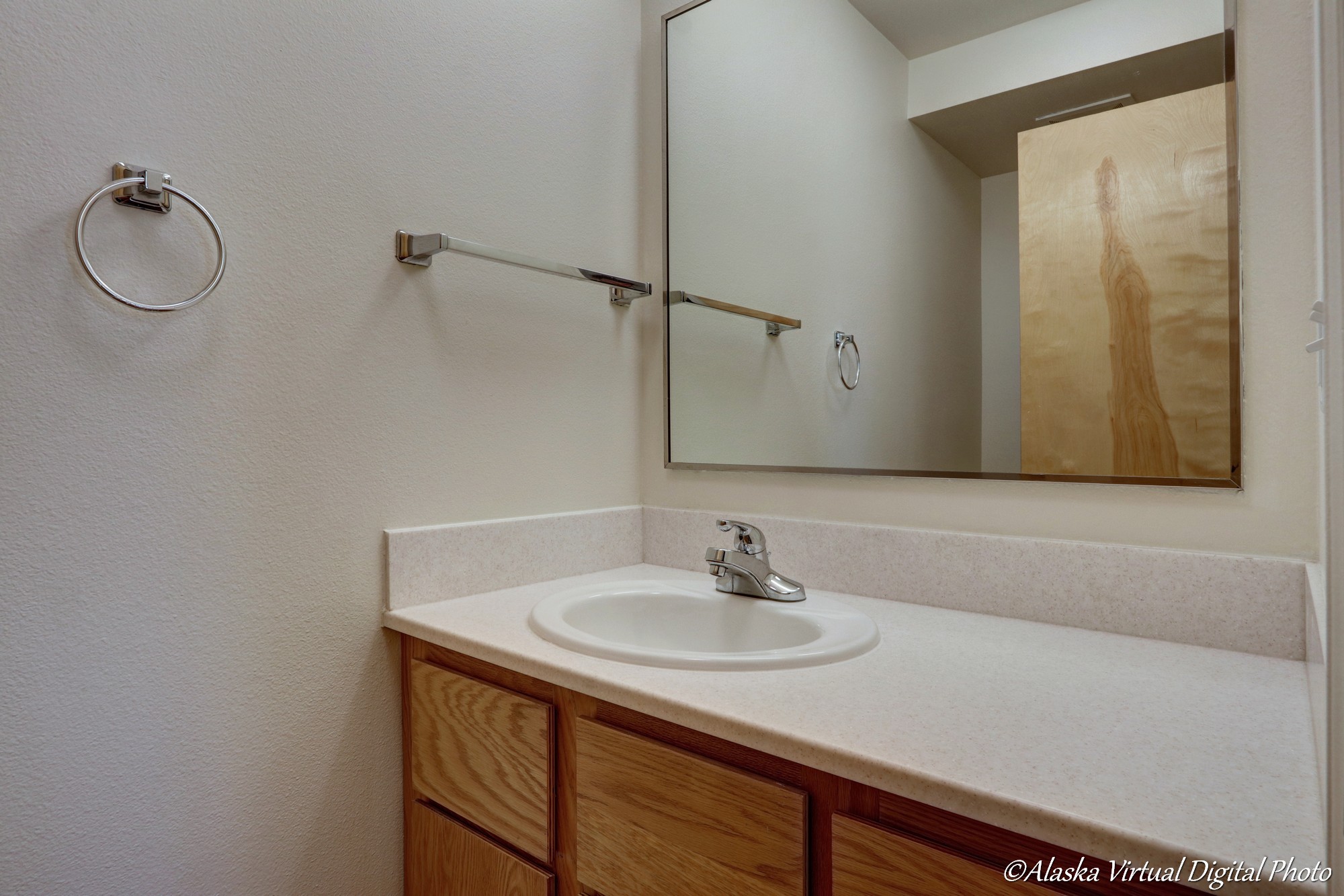 Powder room with white counters on vanity