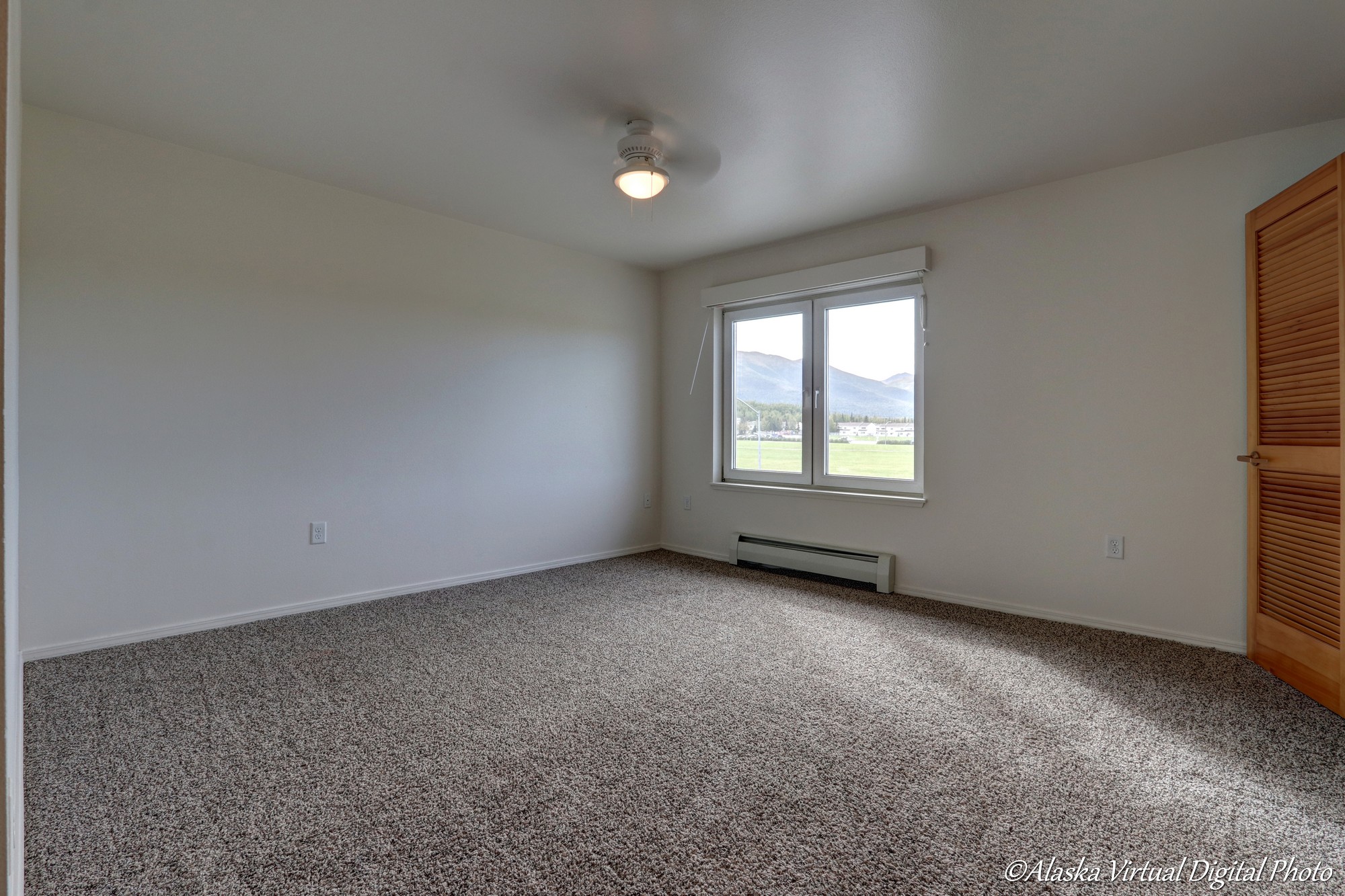 Master bedroom with window and small fan