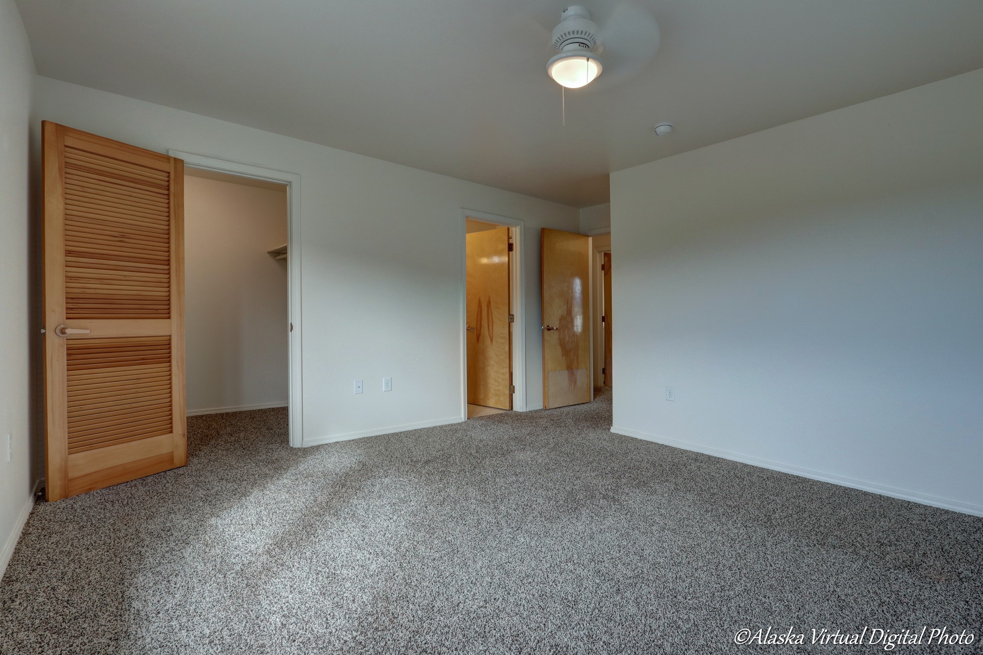 view of closet and in suite bathroom