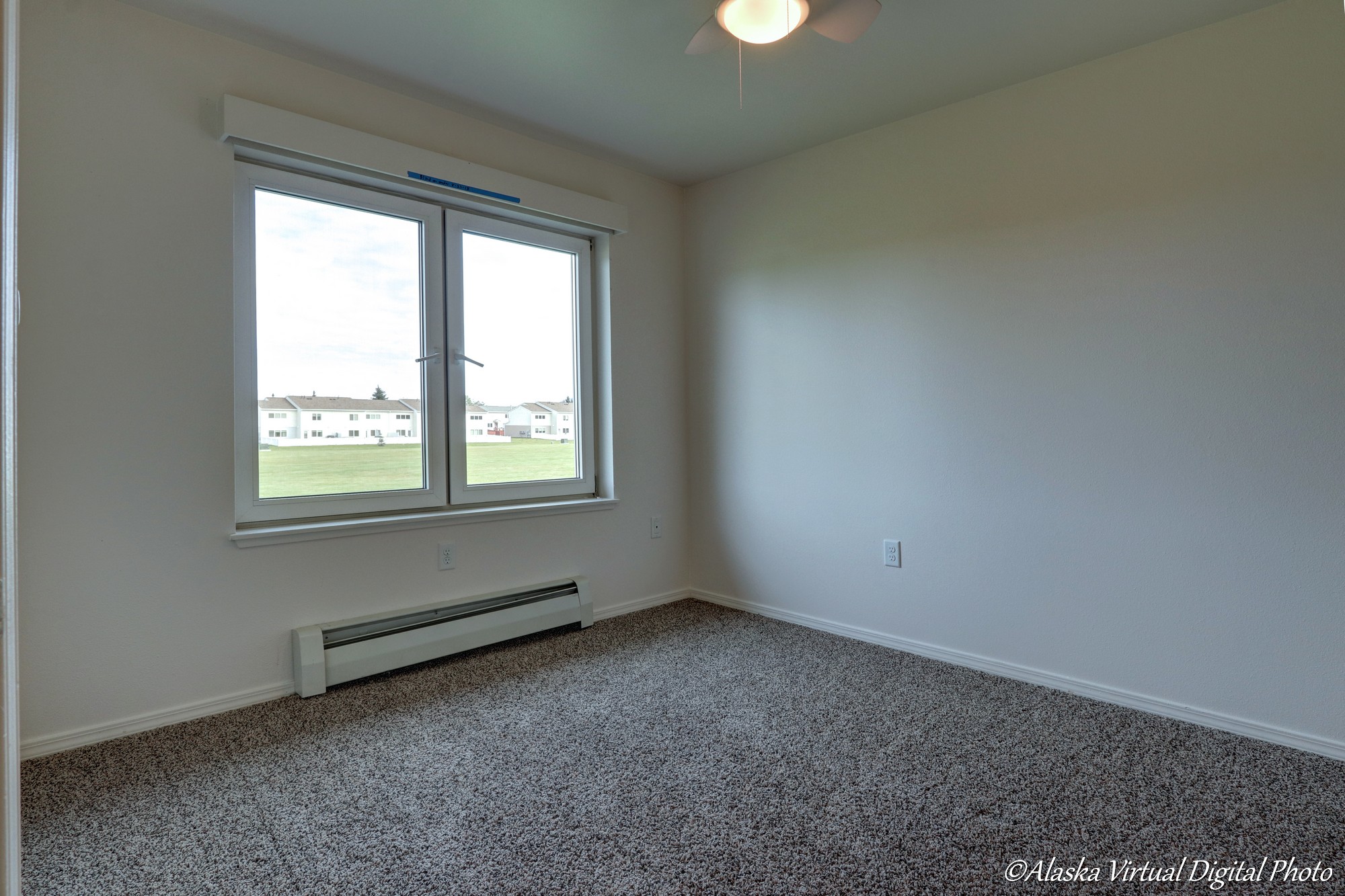 Bedroom with baseboard heater and large window