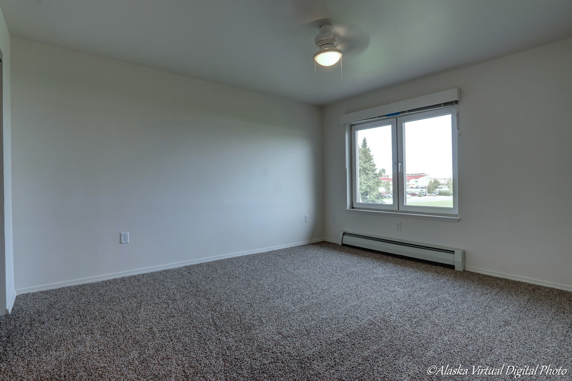 Small fan and windows in bedroom