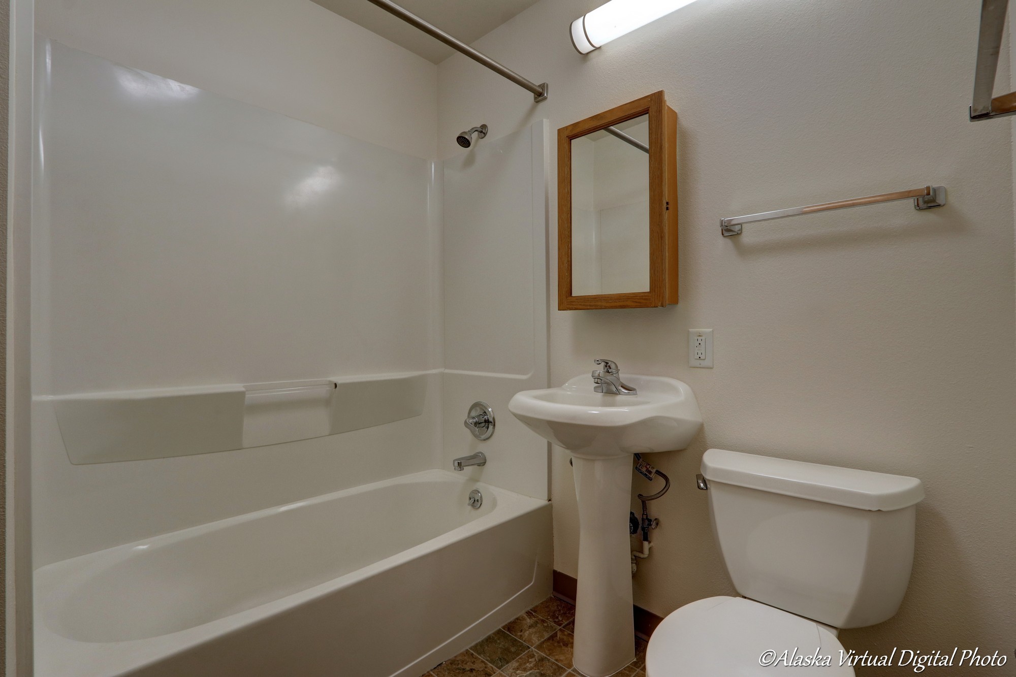 Bathroom with pedestal sink and bathtub