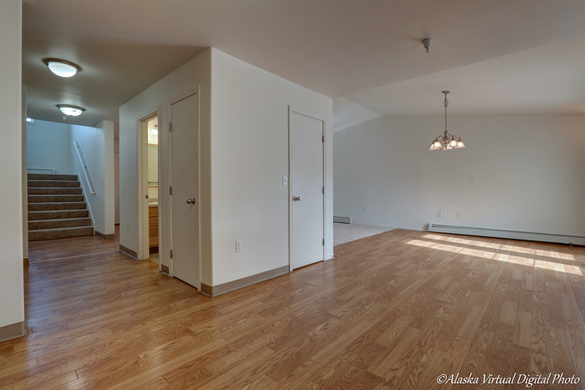 View of dining room and powder room taken from the kitchen