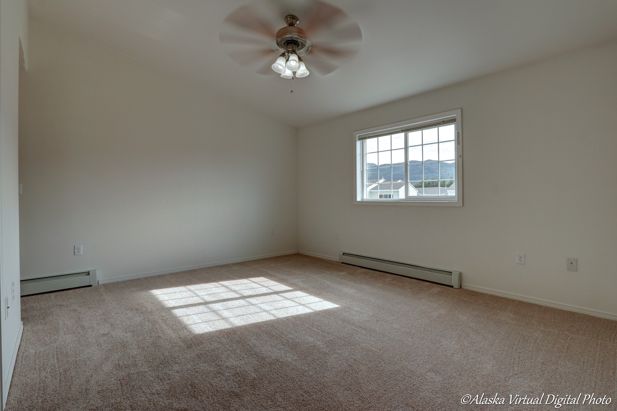 Master bedroom with fan and window