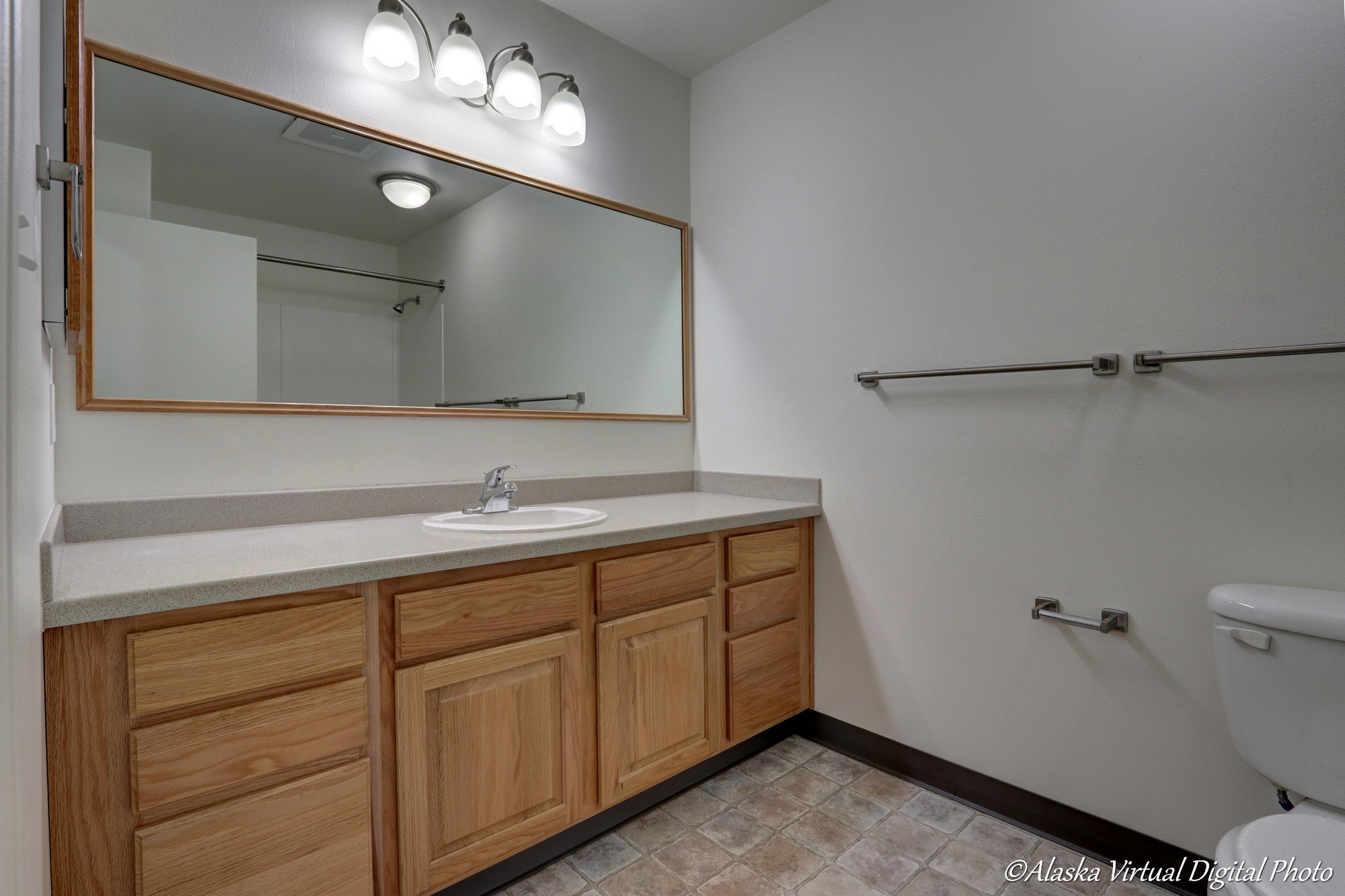 Large counter with single sink in hall bathroom