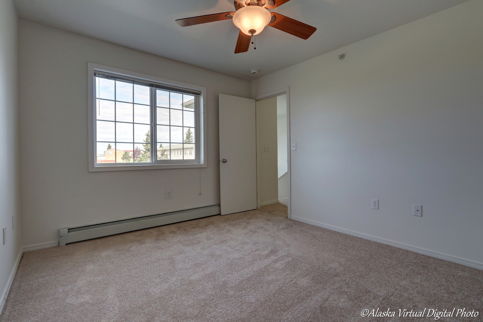 Photo of bedroom with door leading to hallway