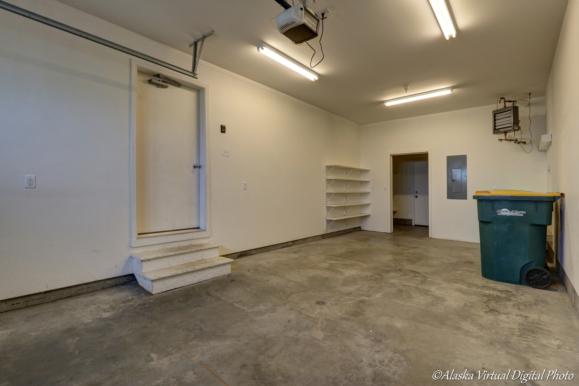 Well lit garage with concrete floor