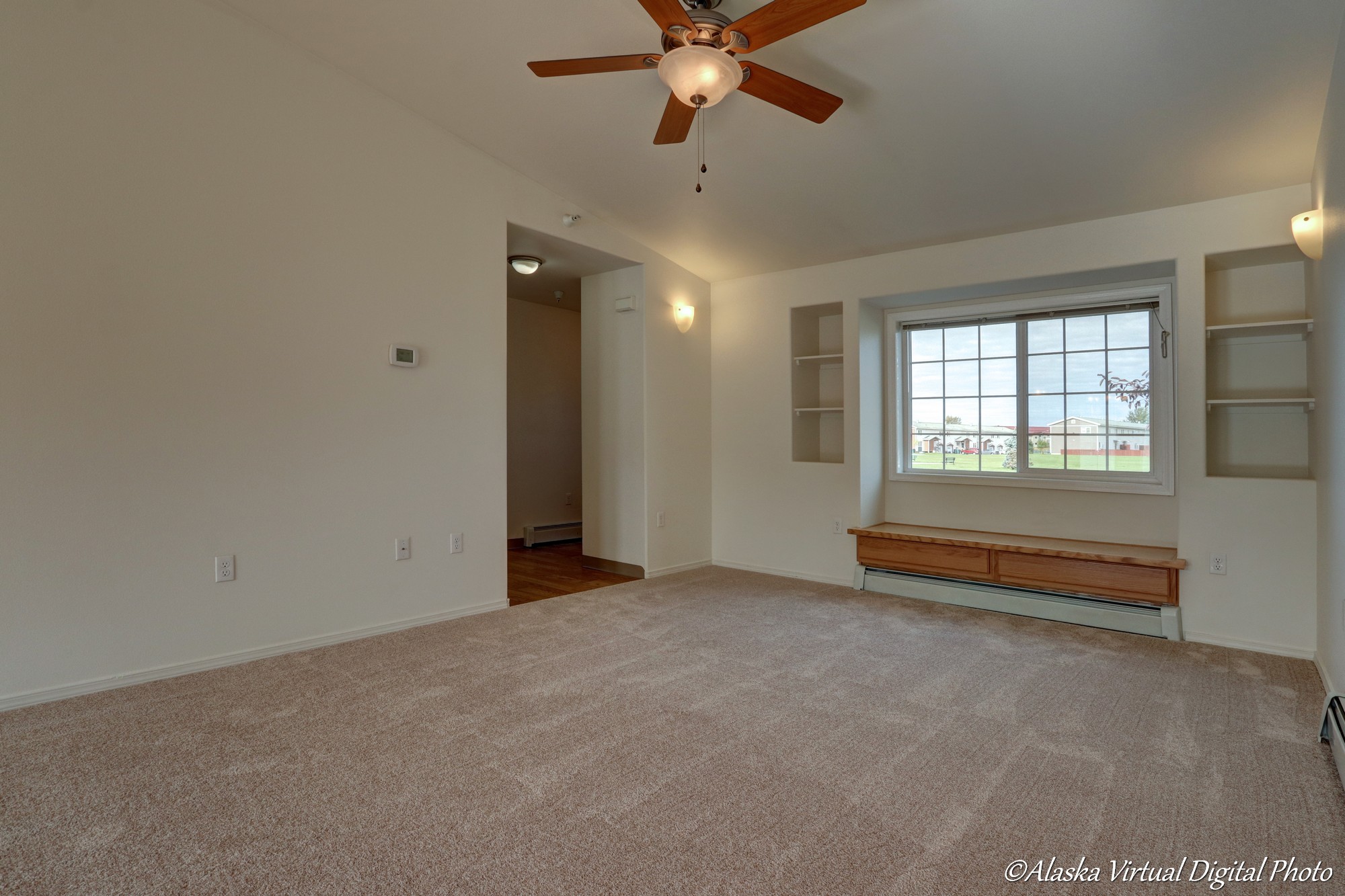 Living room with fan and built in window bench