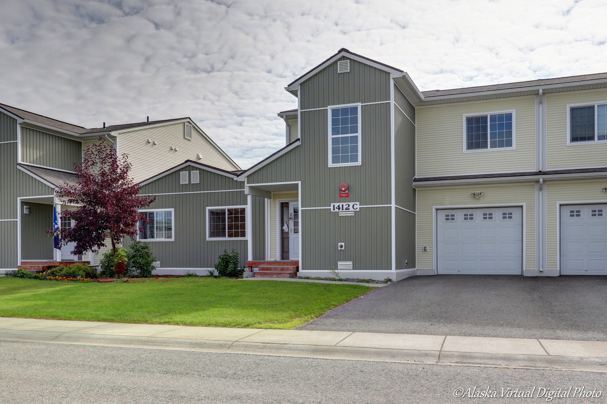 Exterior of home with tan and light green accents