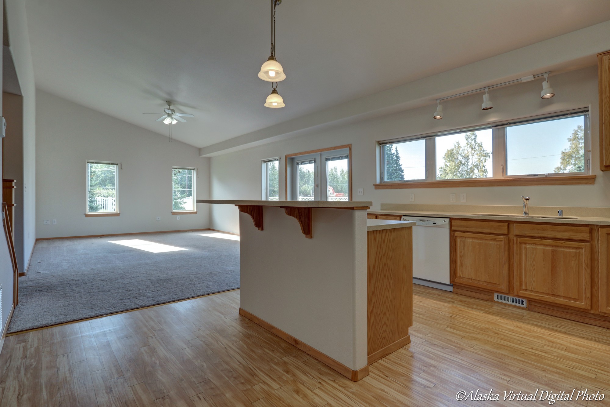 Island in the center of the kitchen with pendant lights