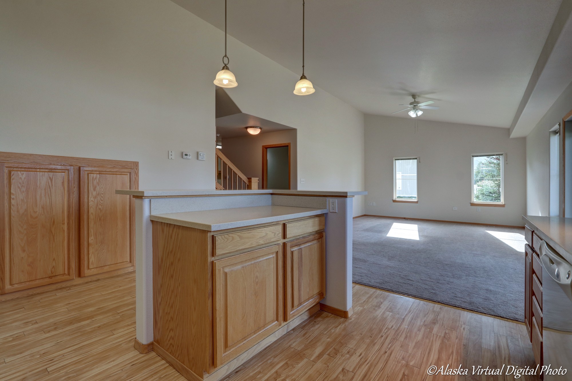 View of kitchen island looking into living/rec area