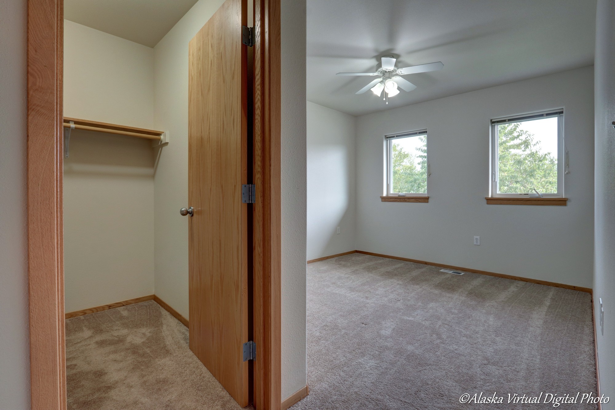 Bedroom with fan and multiple windows