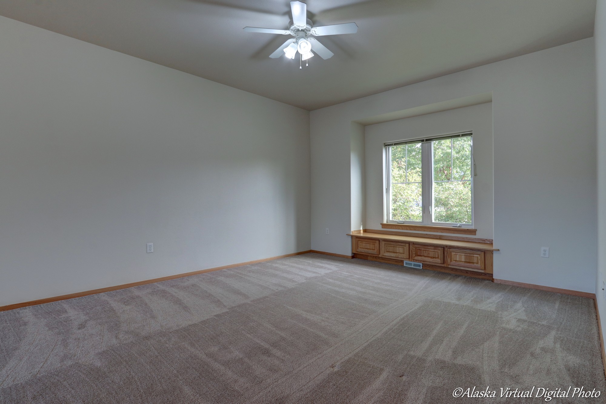 Living room with built in bench and fan.