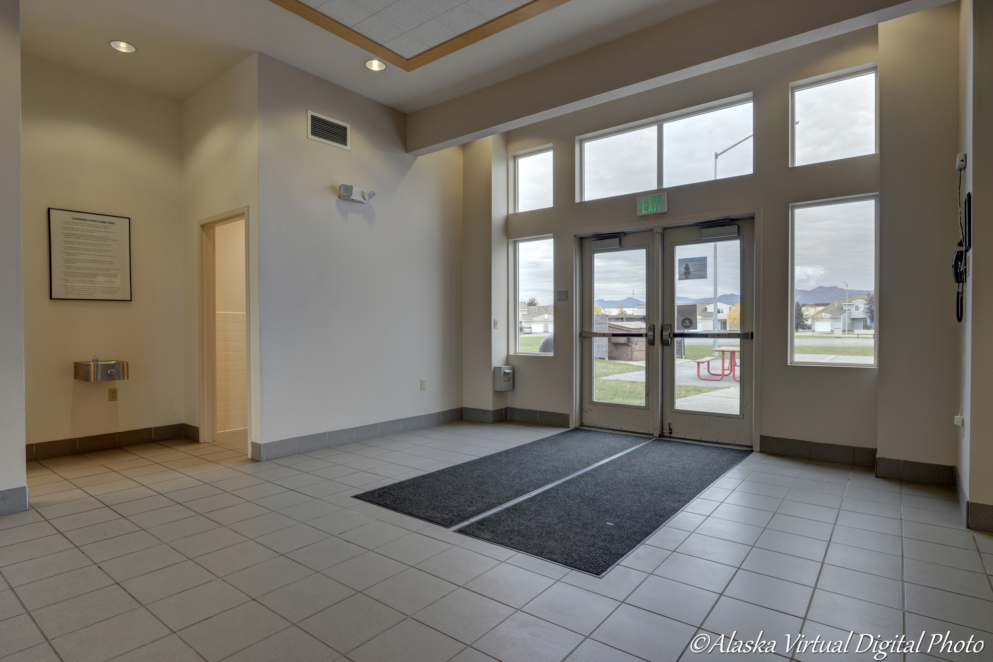 Tiled Entry area with multiple windows and bathrooms