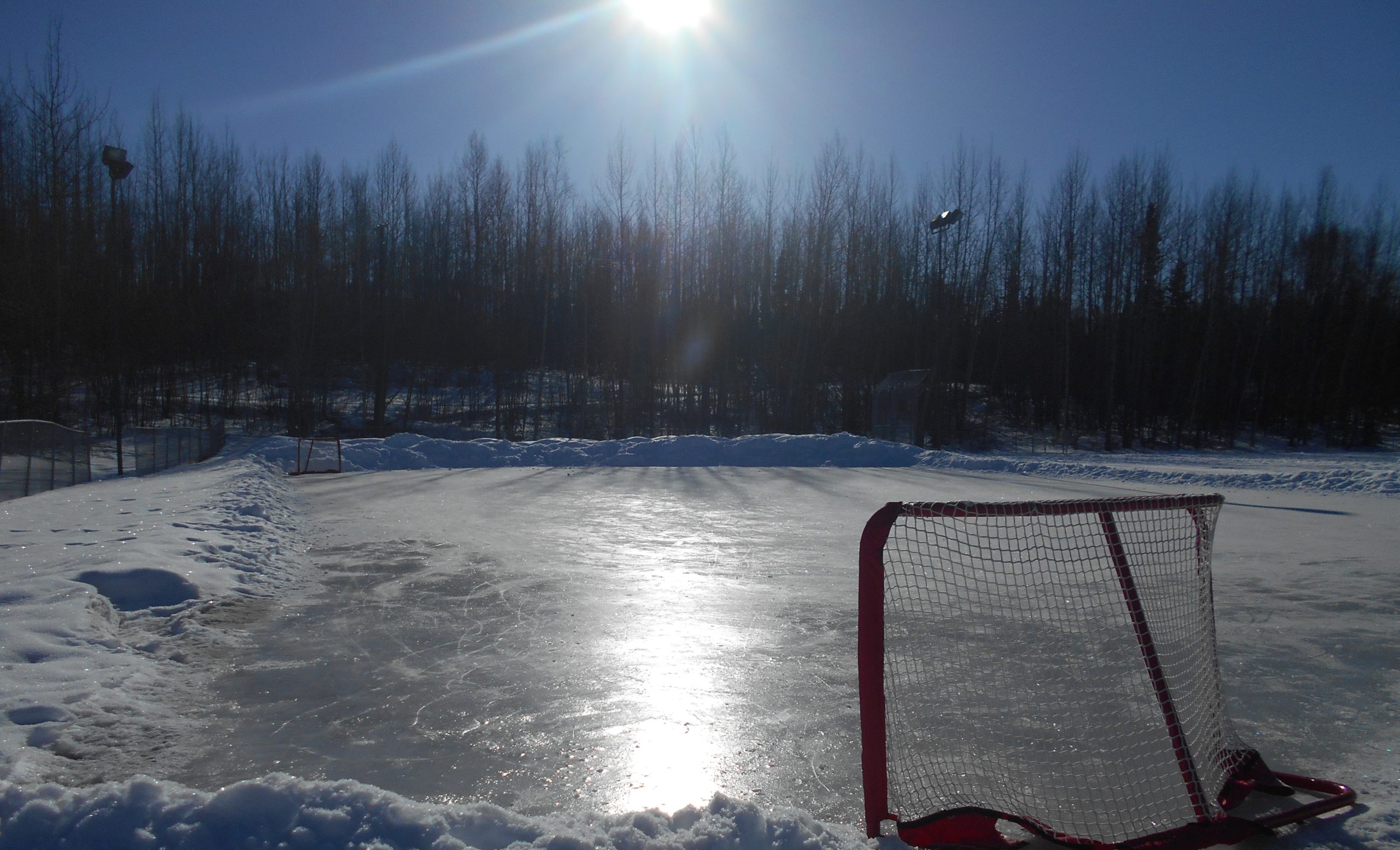 An outdoor hockey rink that has been cleared