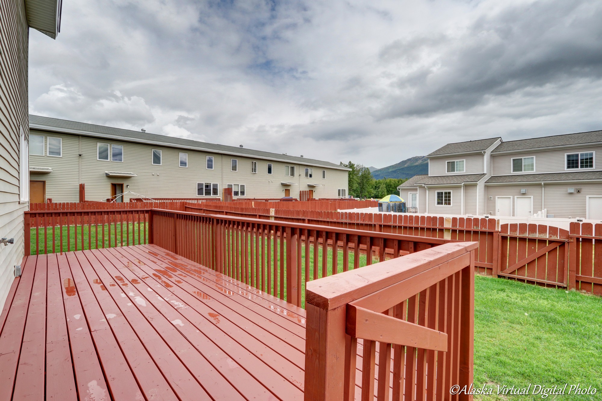 Exterior of the home with a red deck