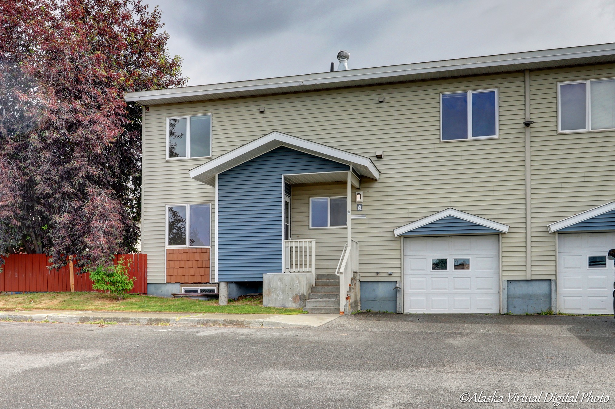 Exterior of home with tan siding and light blue accents