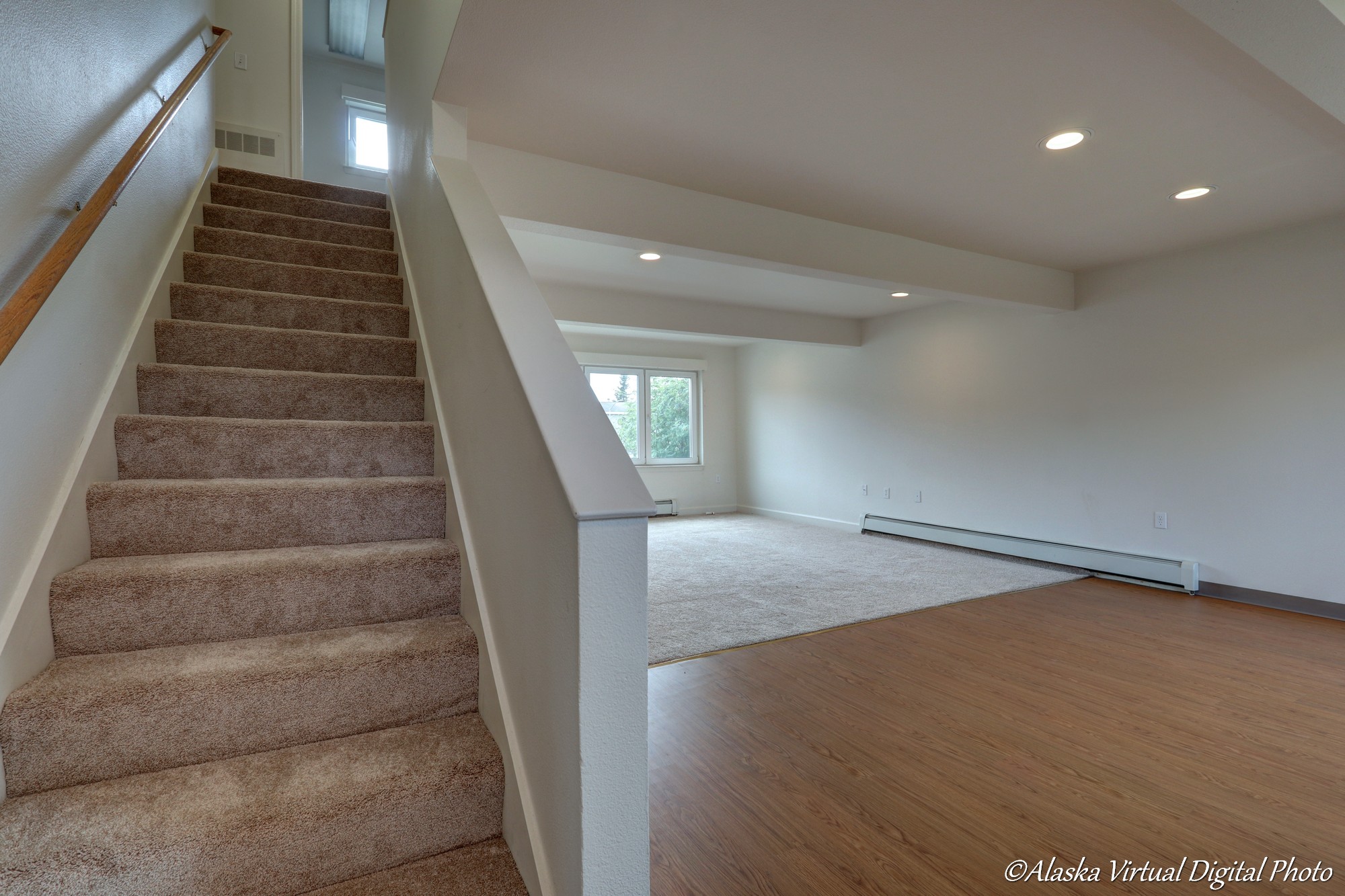 Photo with stairs on left and dining room/living room on right