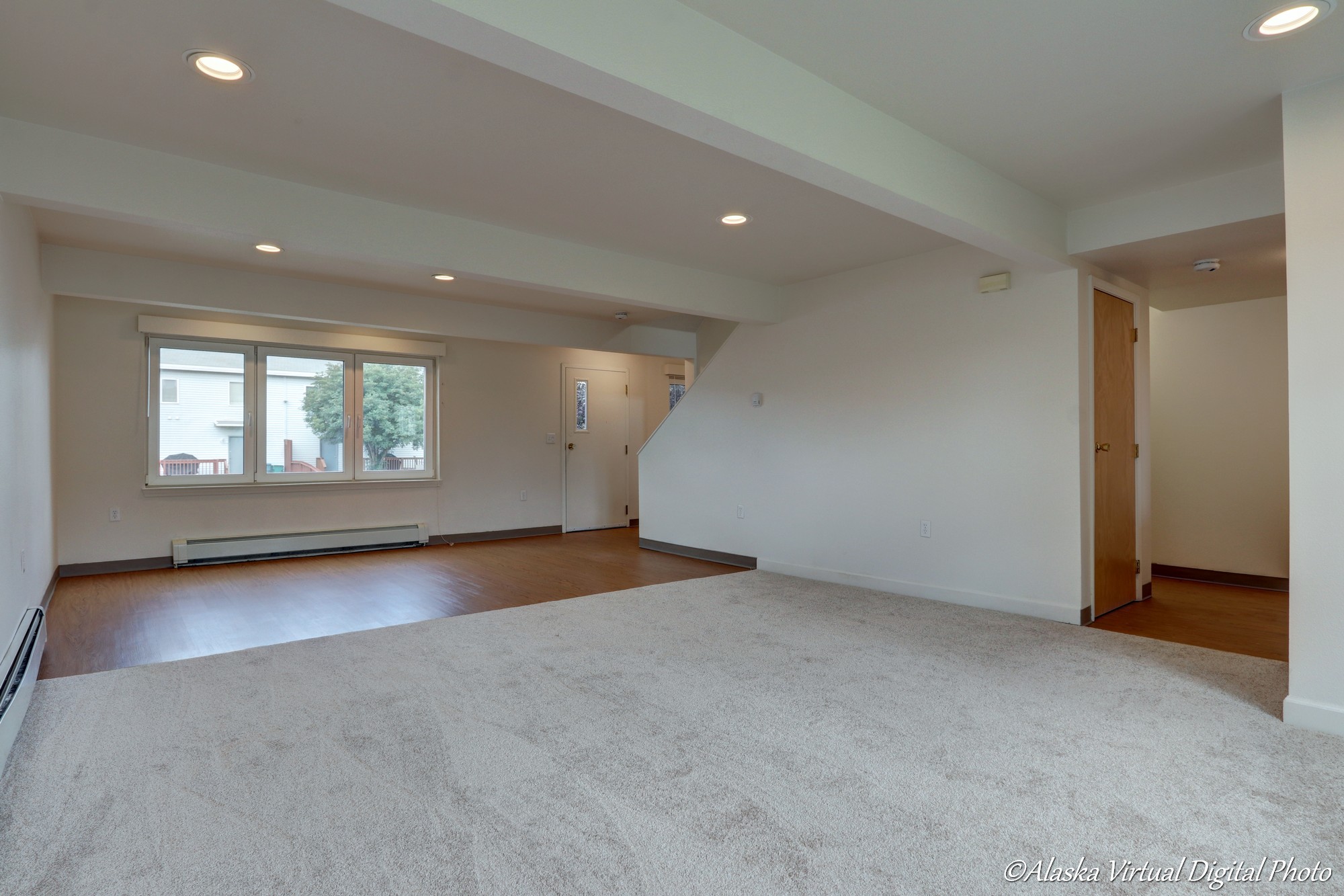 Living room of home with carpet and tile for dining room