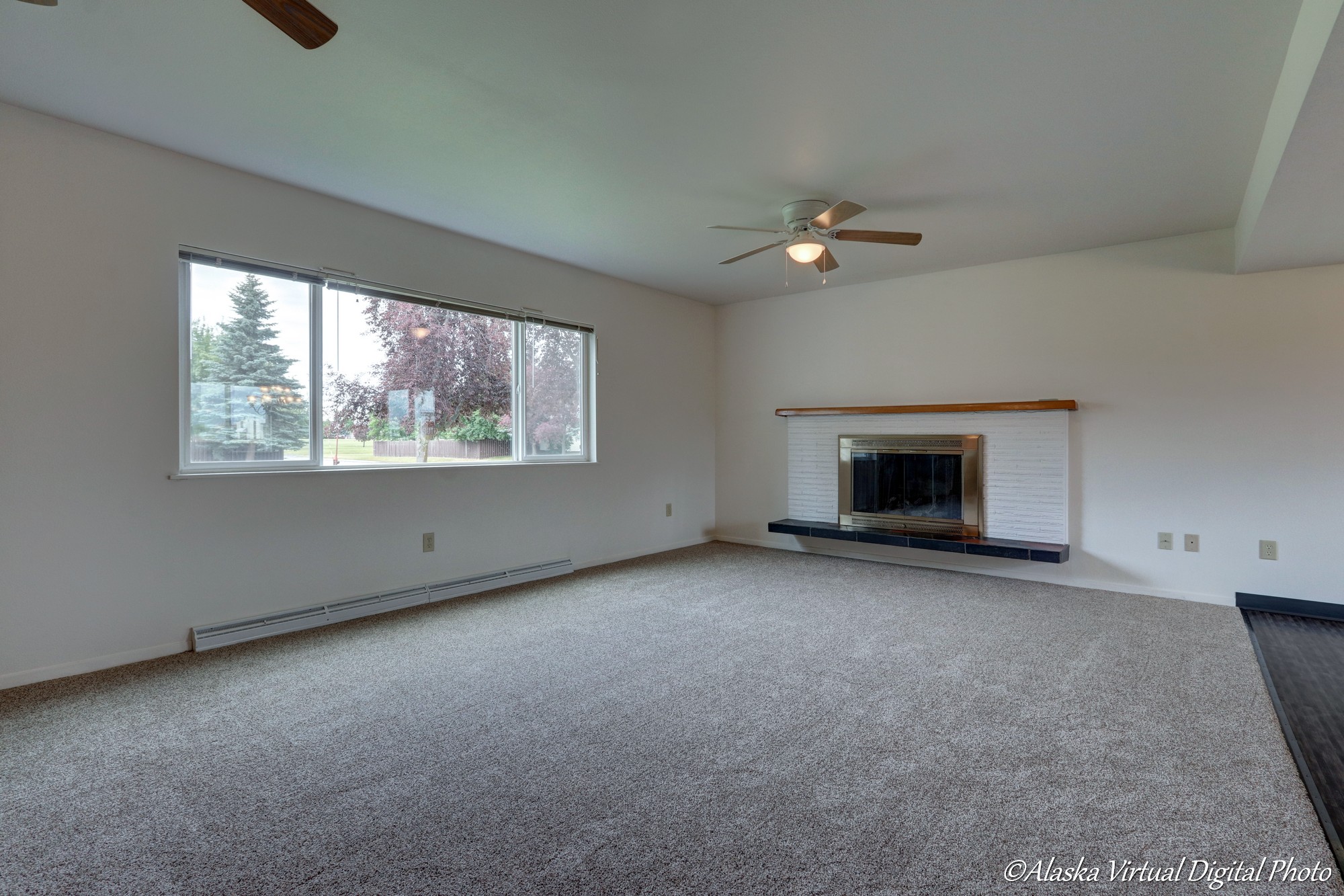 Living Room with large windows and fireplace