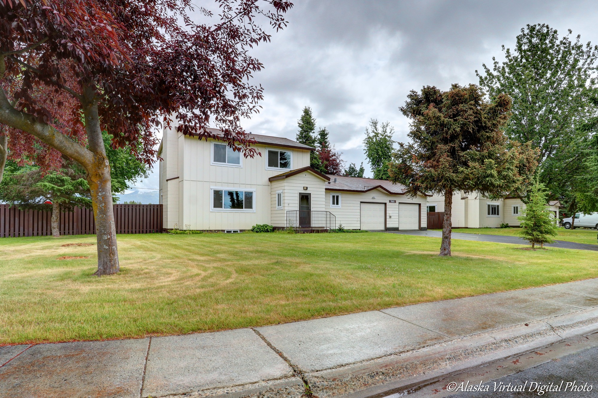 Exterior of home with red leaf trees