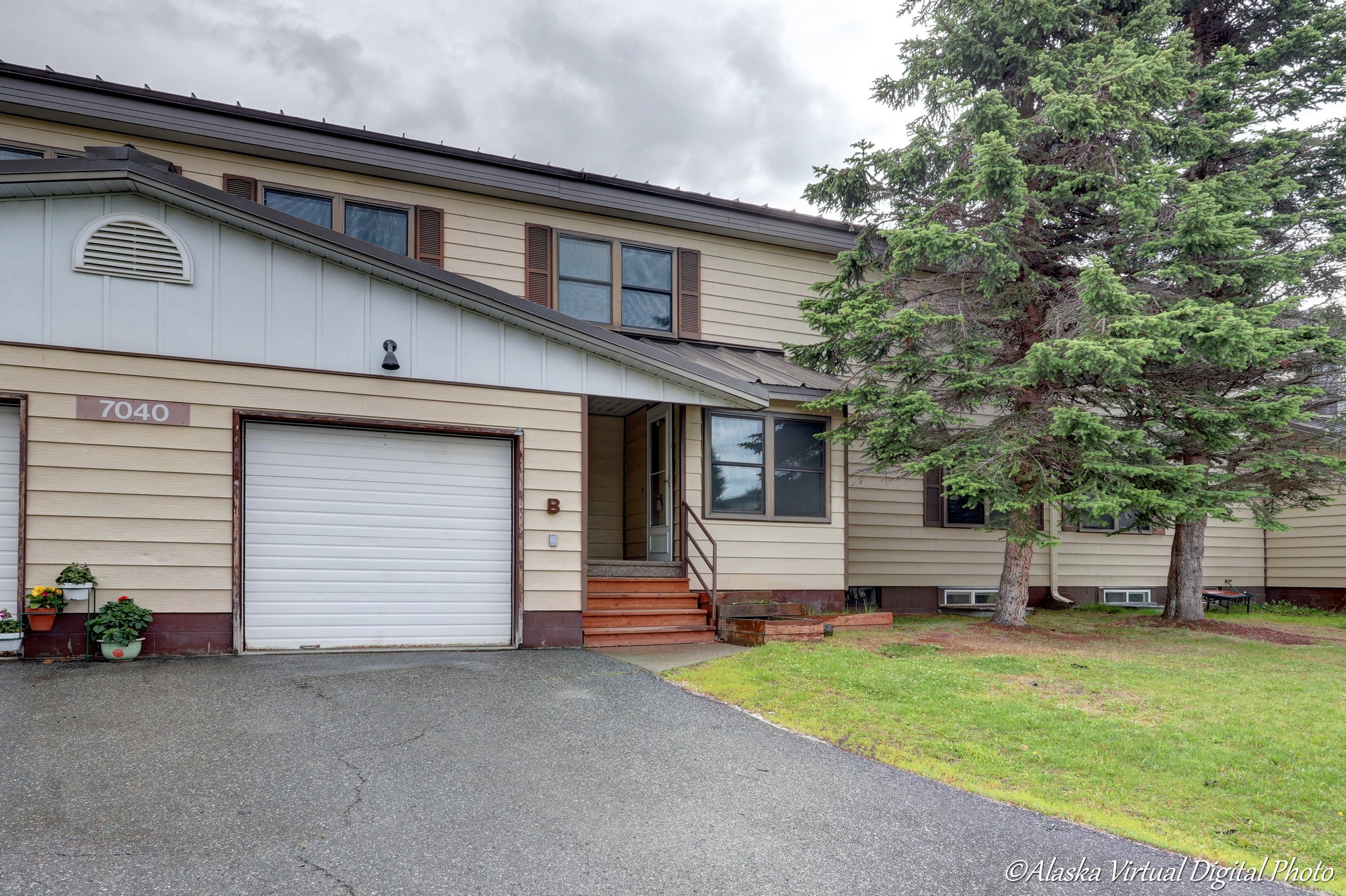 Photo of exterior of home- tan with white garage door