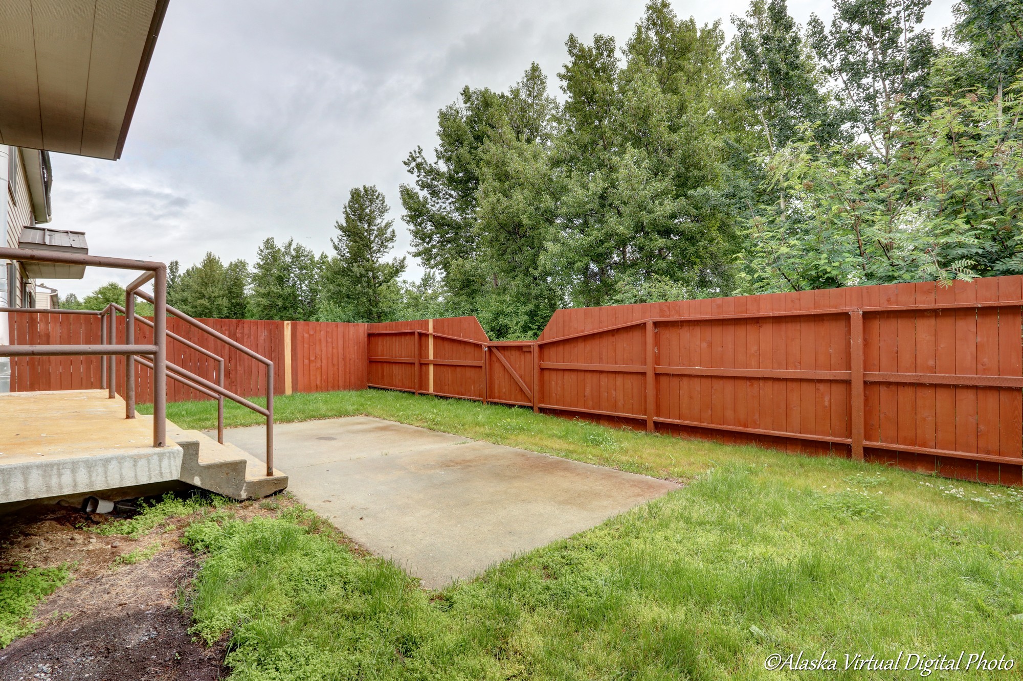 Photo of back yard with red fence