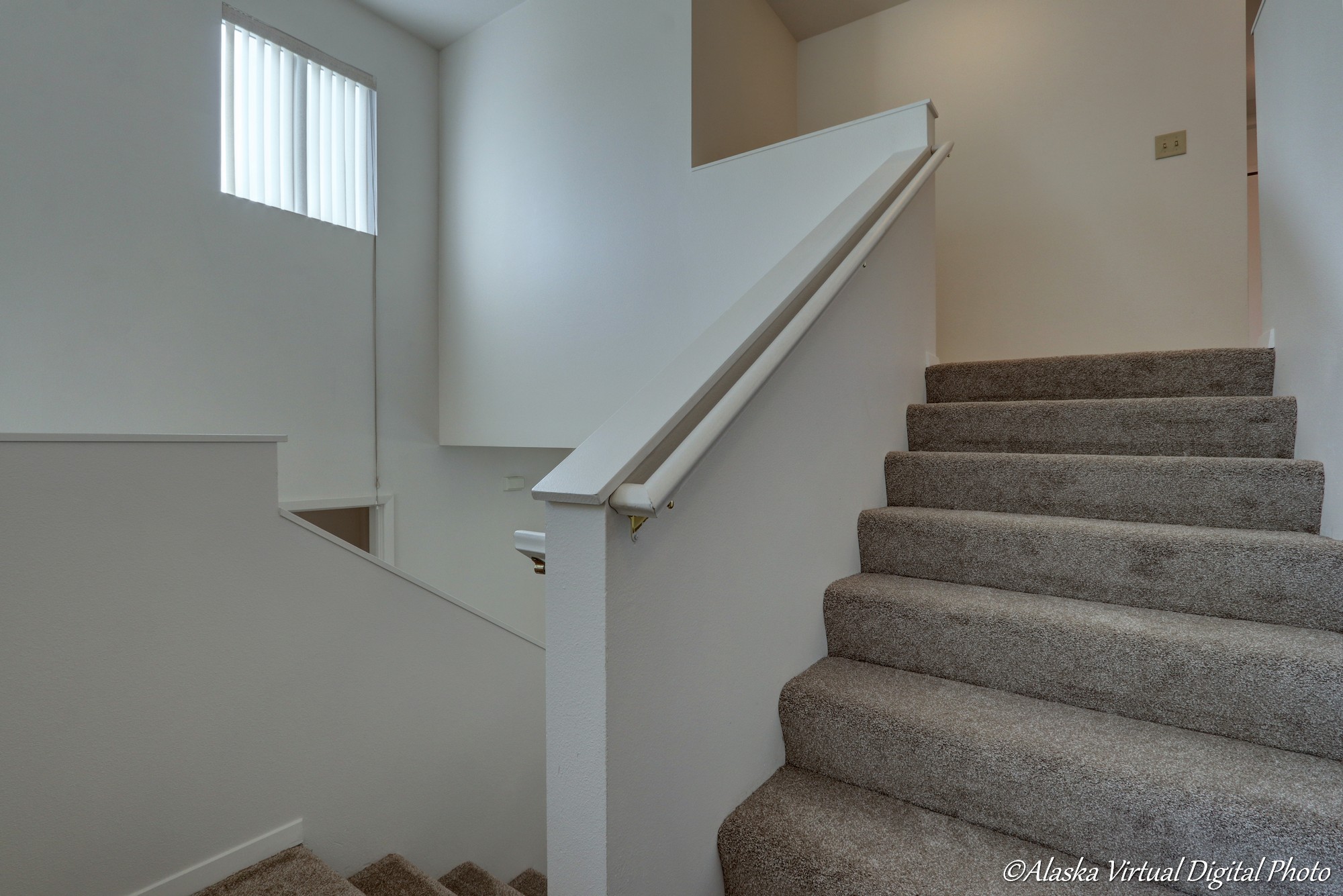 Image of stairway with large windows to the left