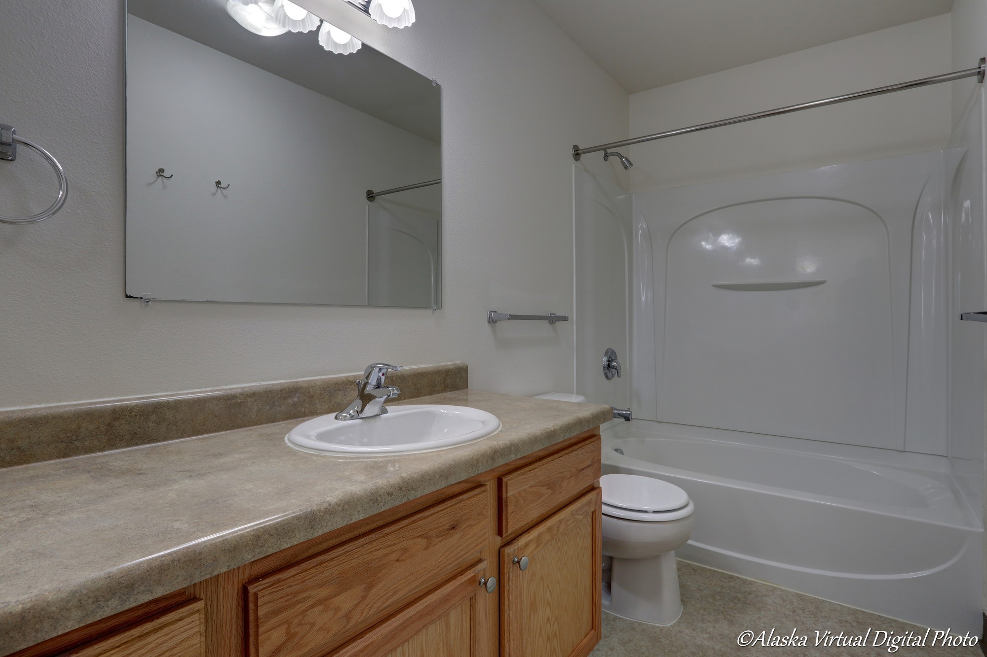 Image of upstairs bathroom with sink, mirror, vanity, and tub.