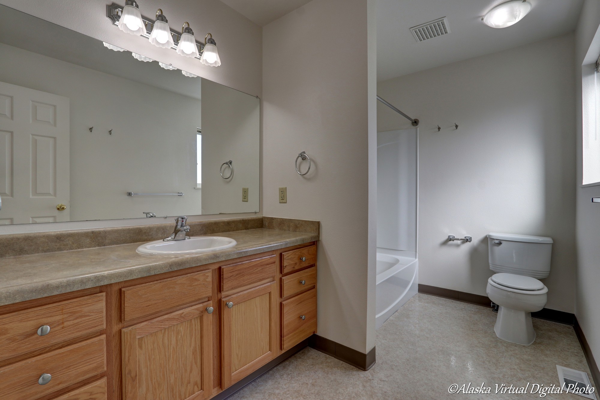 Image of vanity, tub, and toilet in master bedroom.