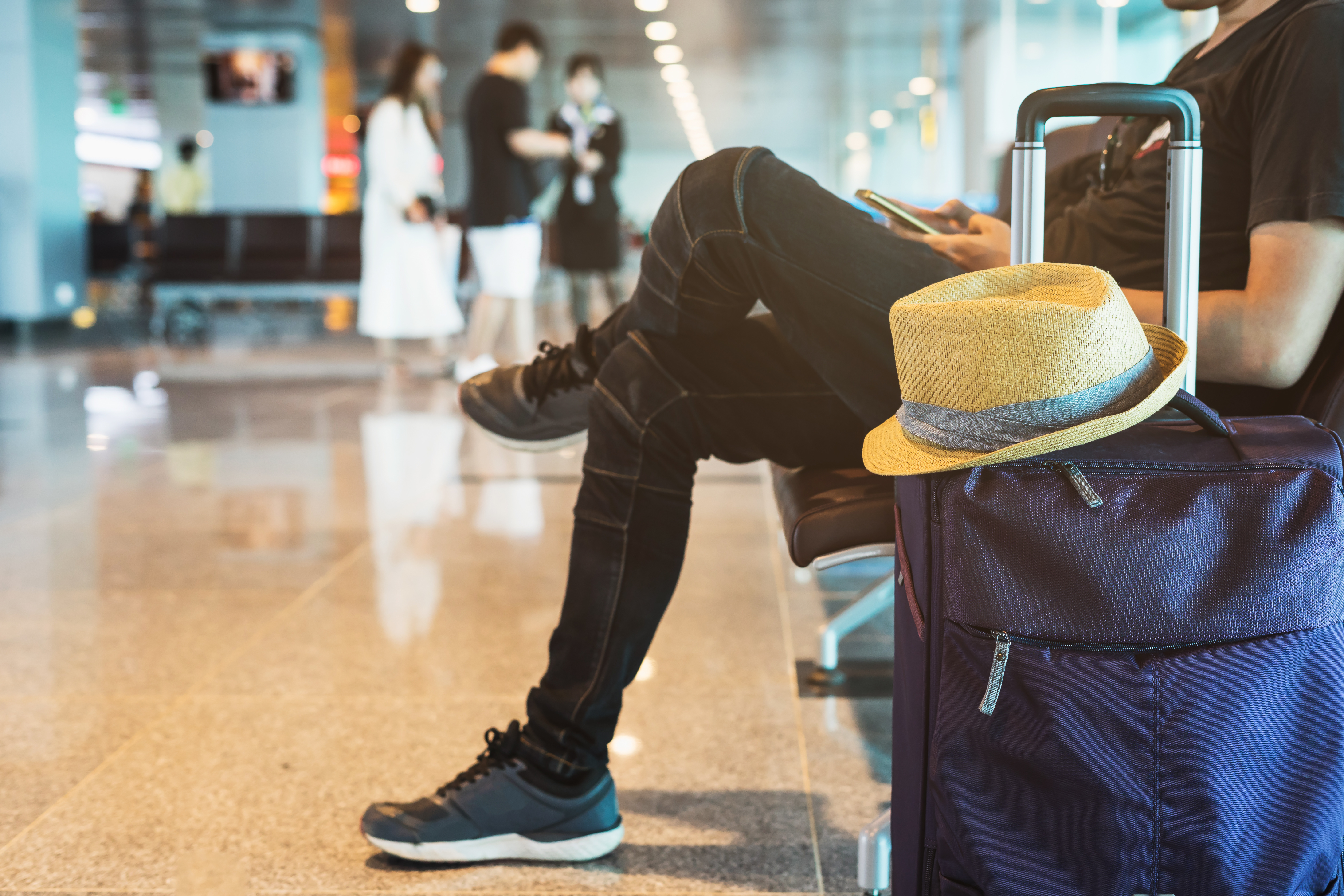 Guy sitting with luggage at airport
