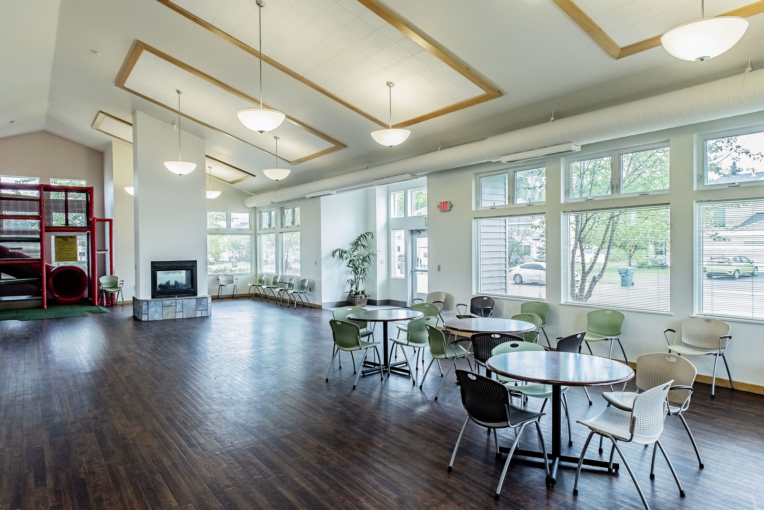 moose crossing community center seating area with vaulted ceiling and fireplace