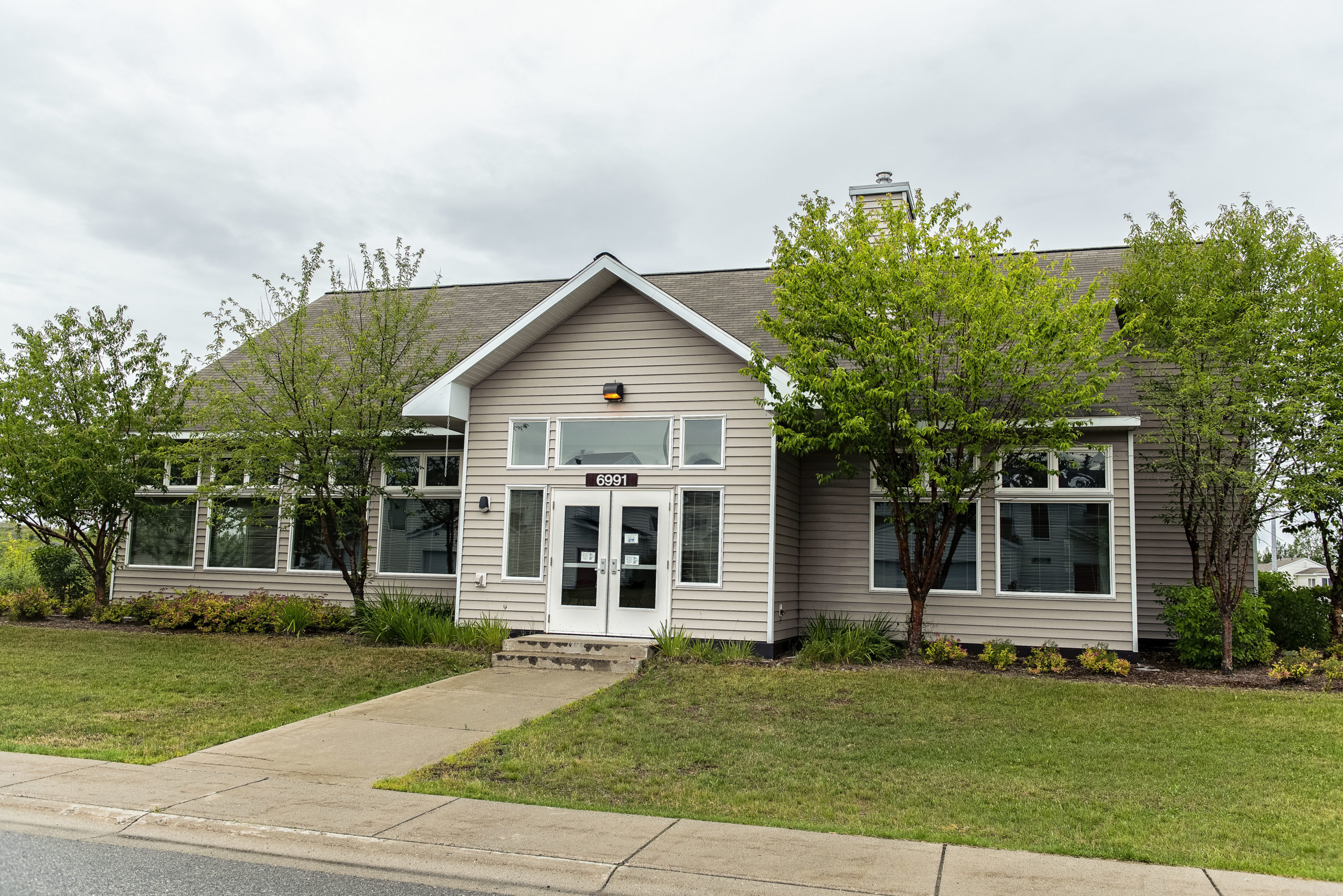 exterior of community center with trees and garden