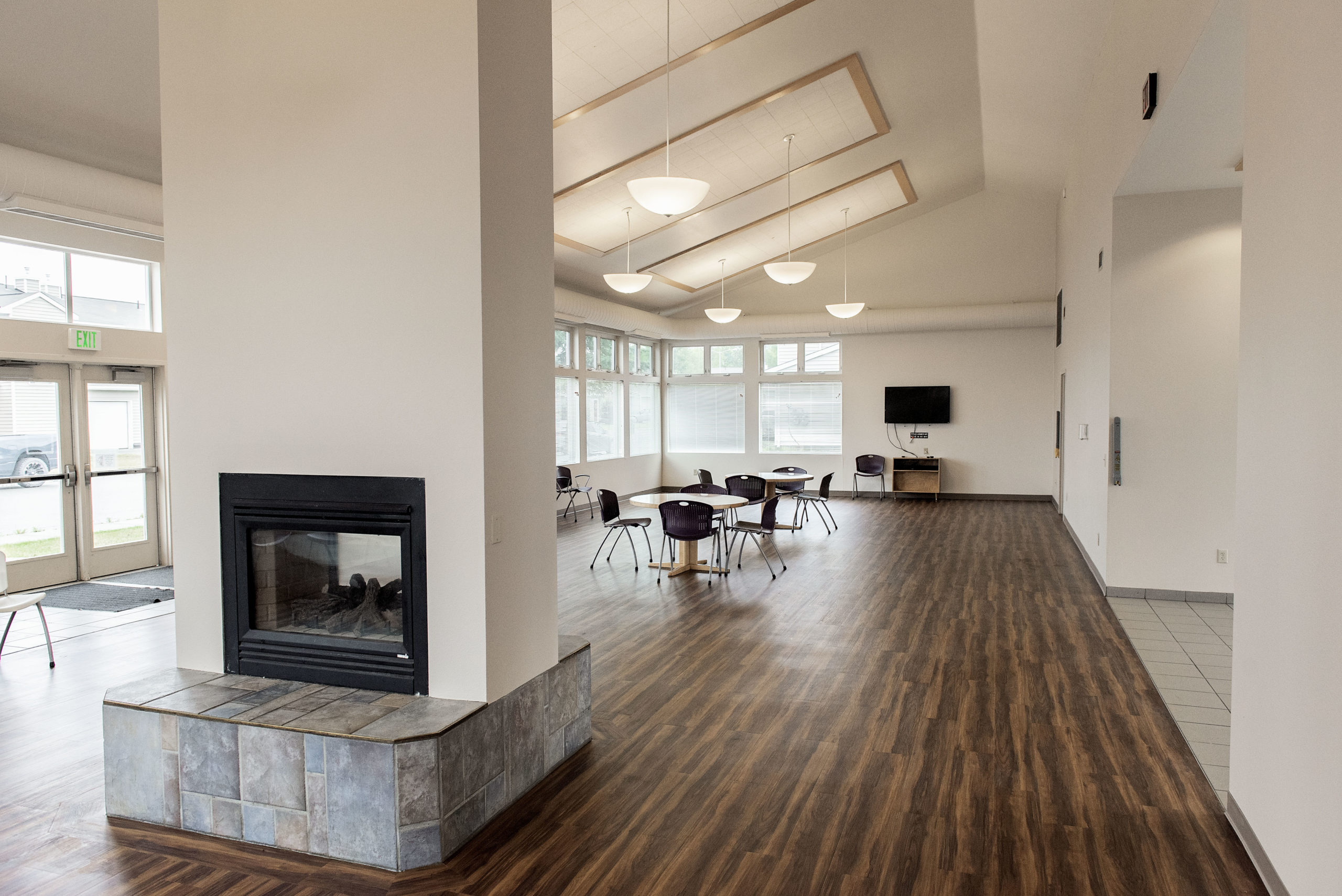 interior of silver run community center, wood flooring, fireplace, vaulted ceilings