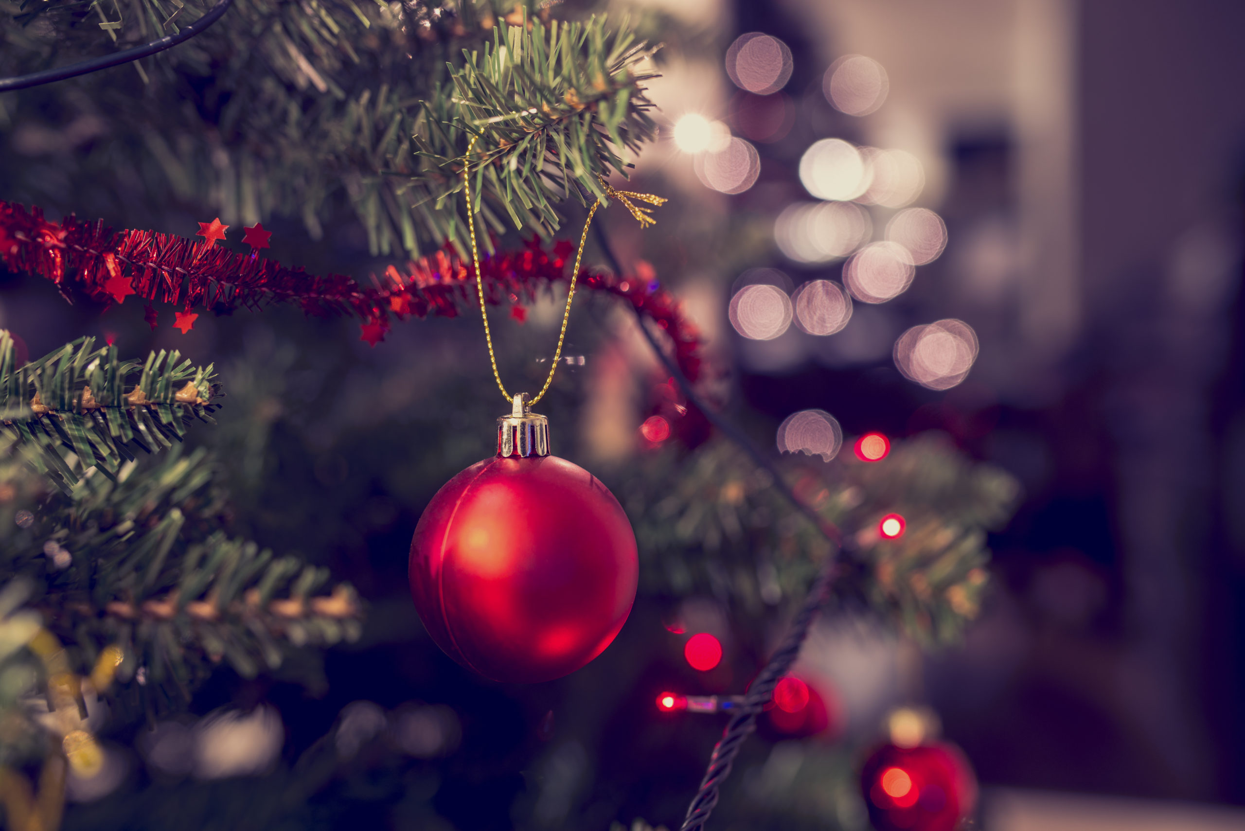 close up of christmas tree with shiny ornaments