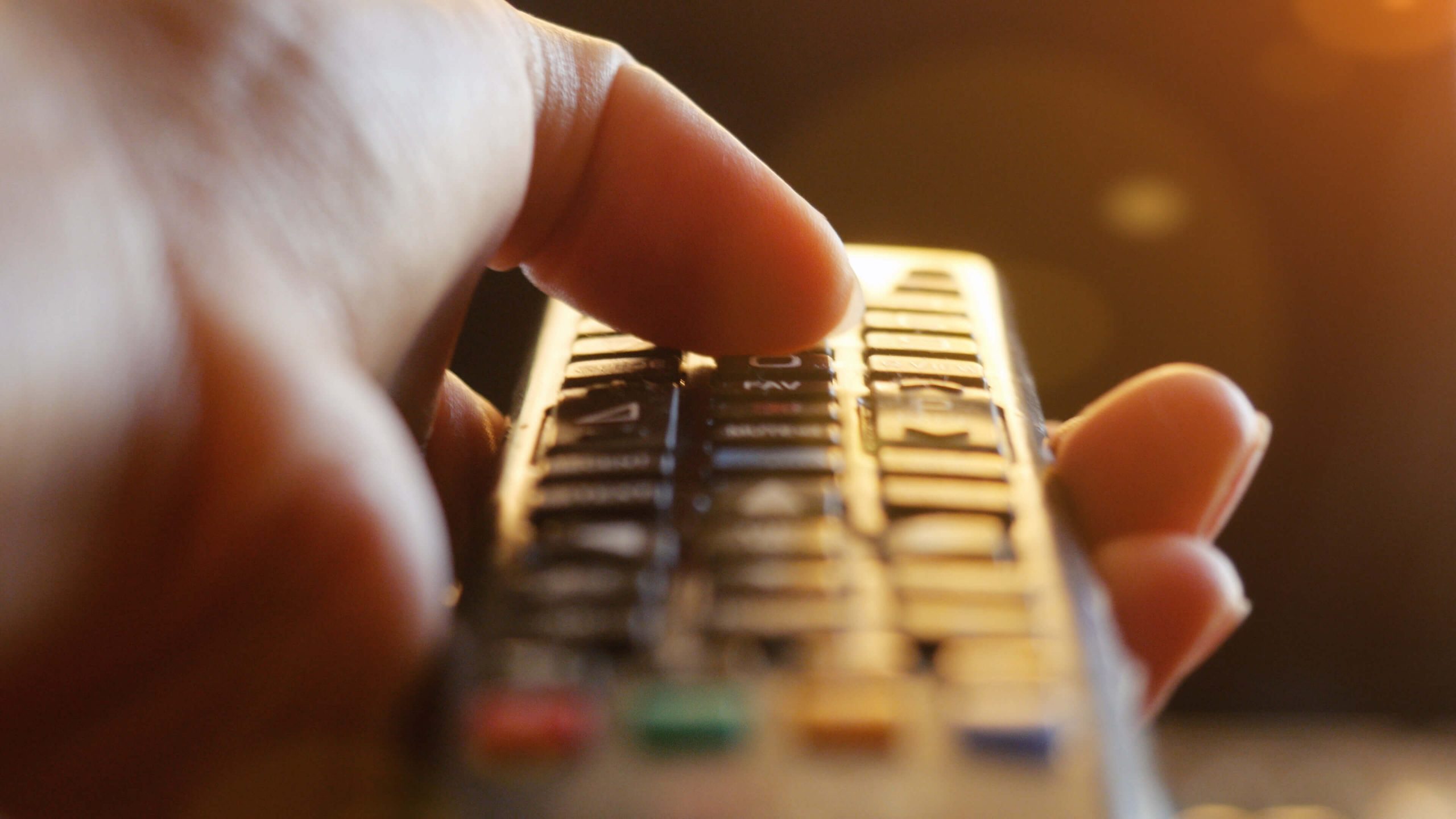 close up of hand holding remote