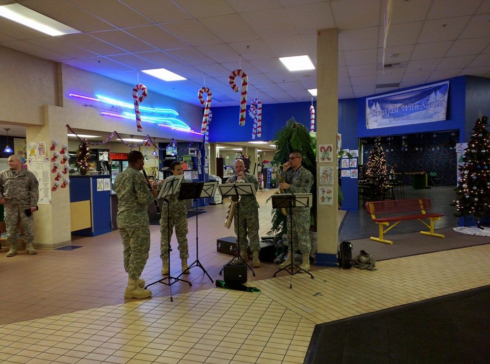 band playing surrounded by holiday decorations