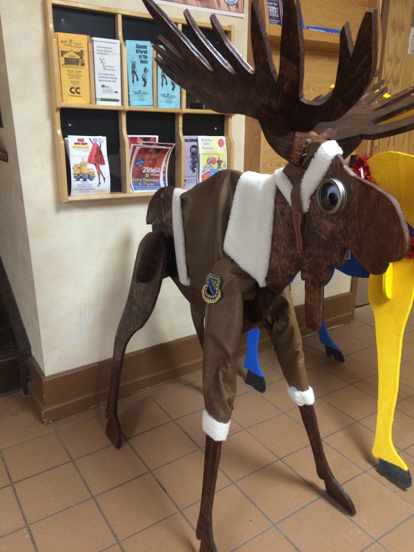 wooden moose dressed up like santa